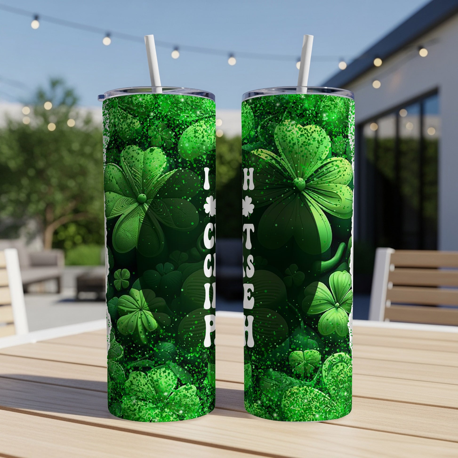 Green shamrock tumbler with "I kiss people" text on an outdoor table.