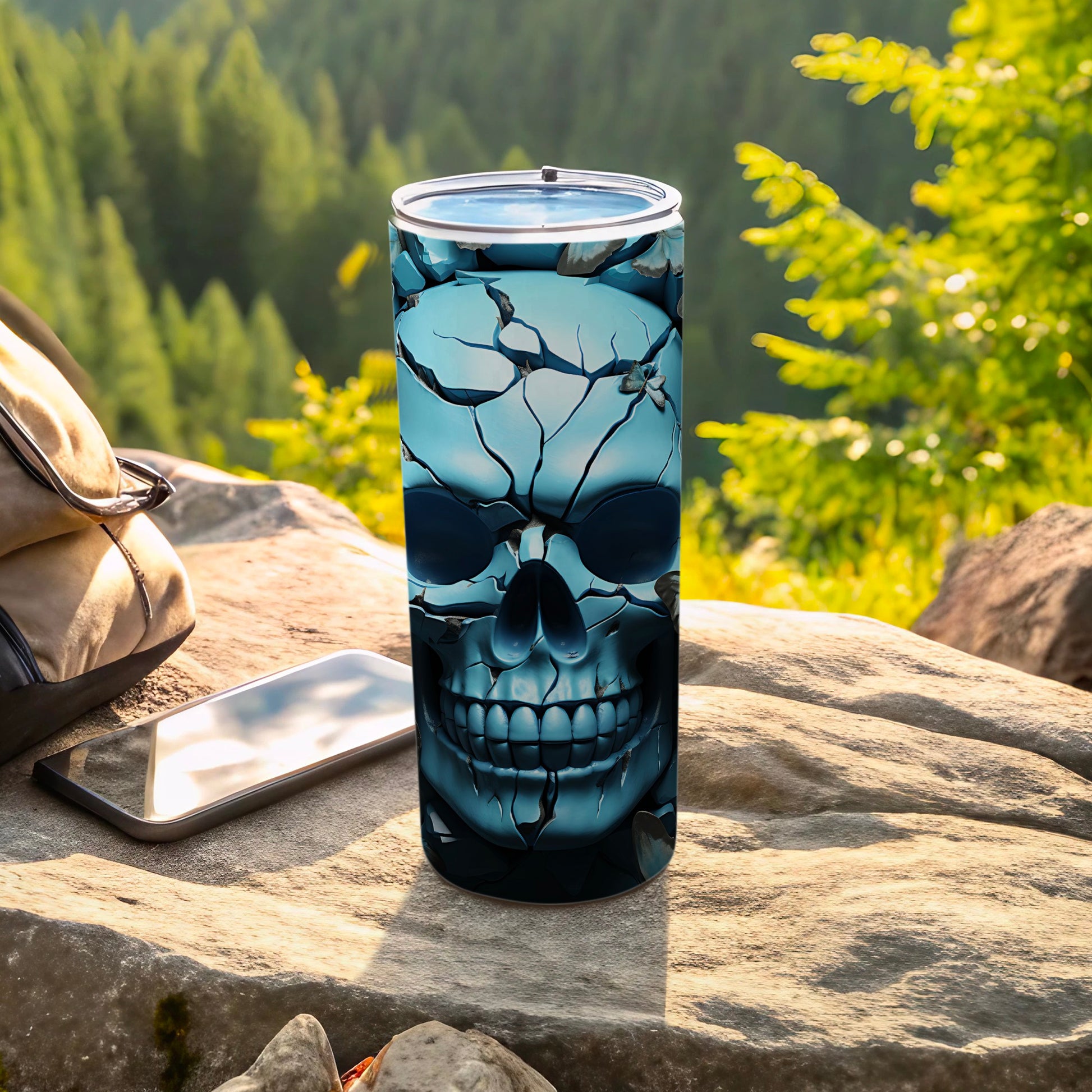 Skull tumbler on rock with phone and backpack, forest background.