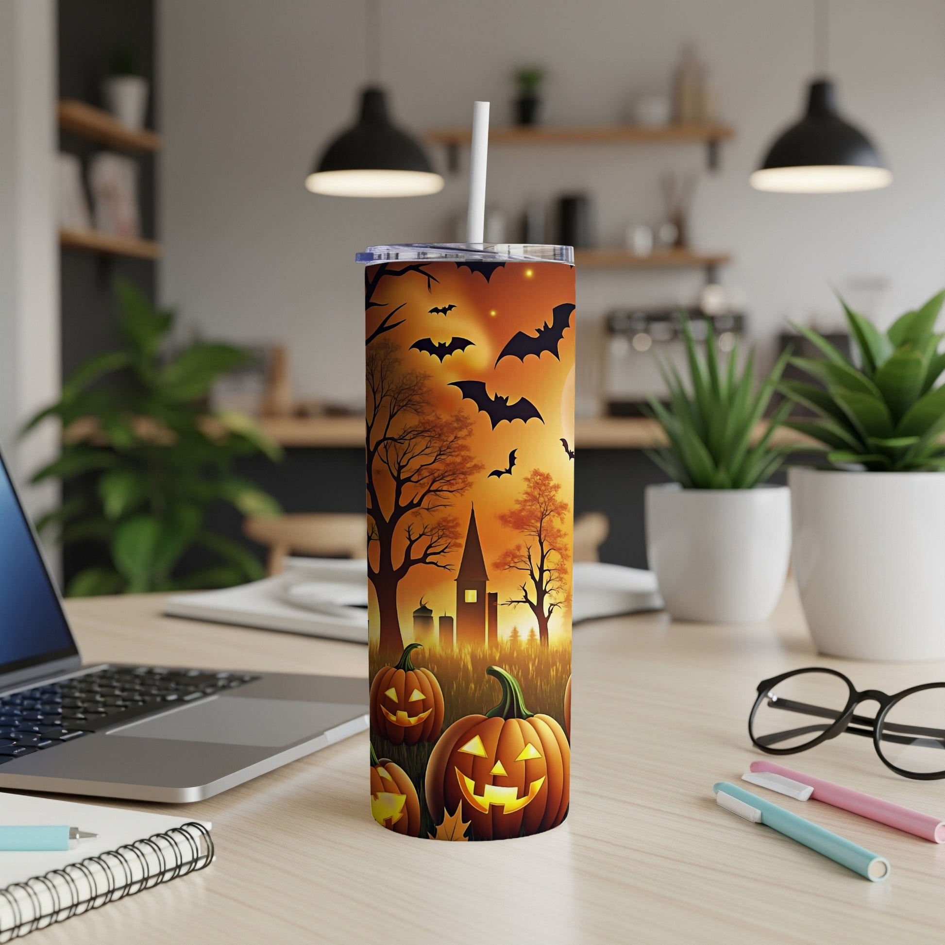 Tumbler with Halloween pumpkins, bats, and spooky castle on orange sunset background.