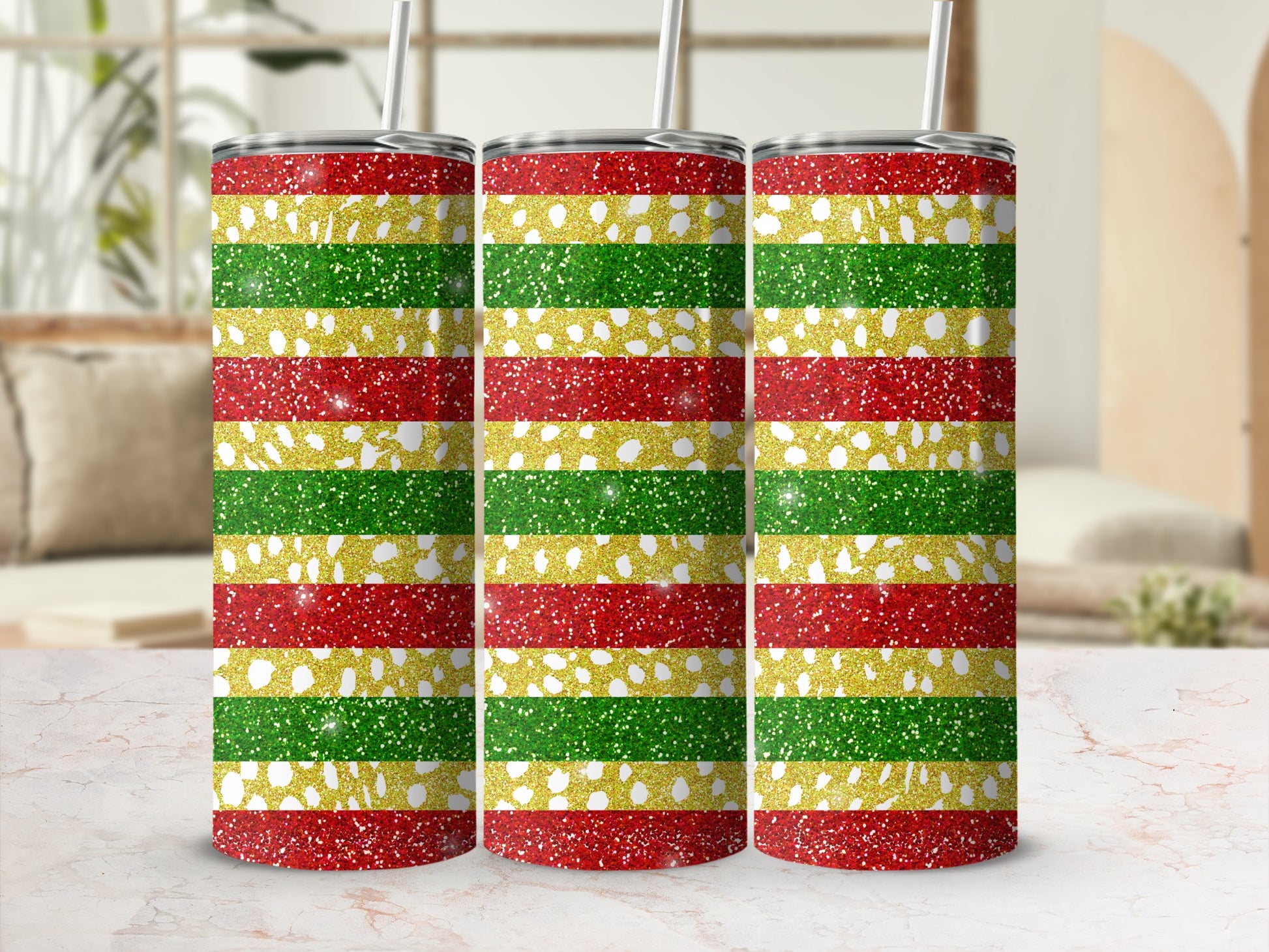 Three glittery tumblers with red, gold, and green horizontal stripes.