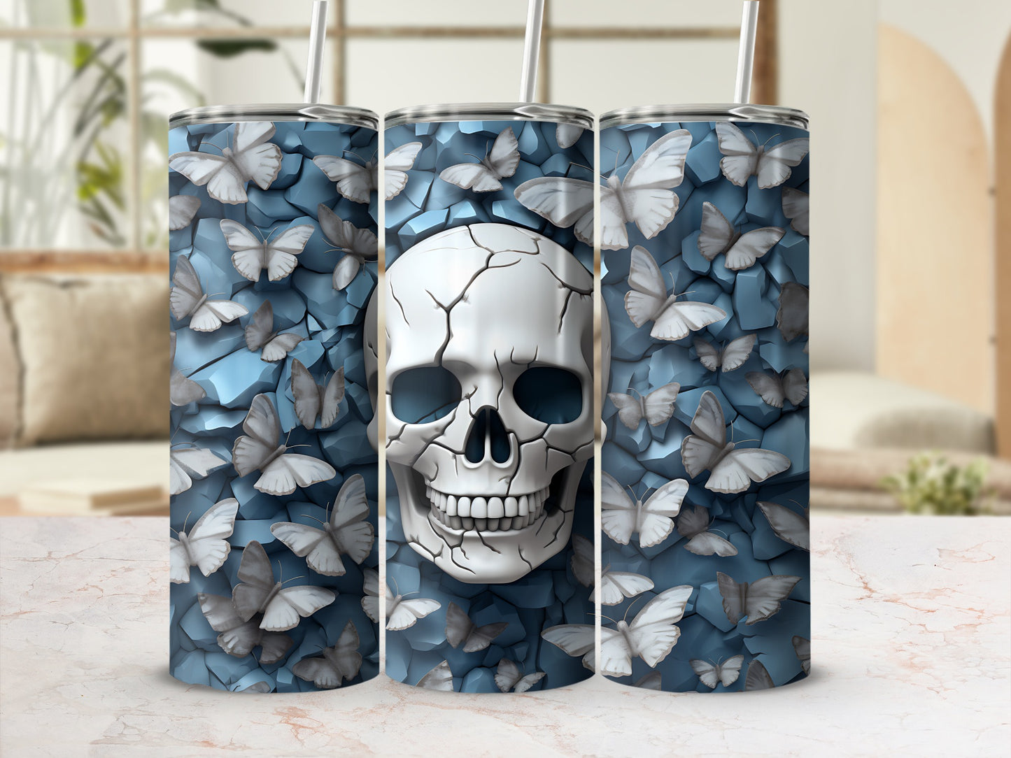 Three tumblers featuring a cracked skull surrounded by light blue butterflies on a textured background.