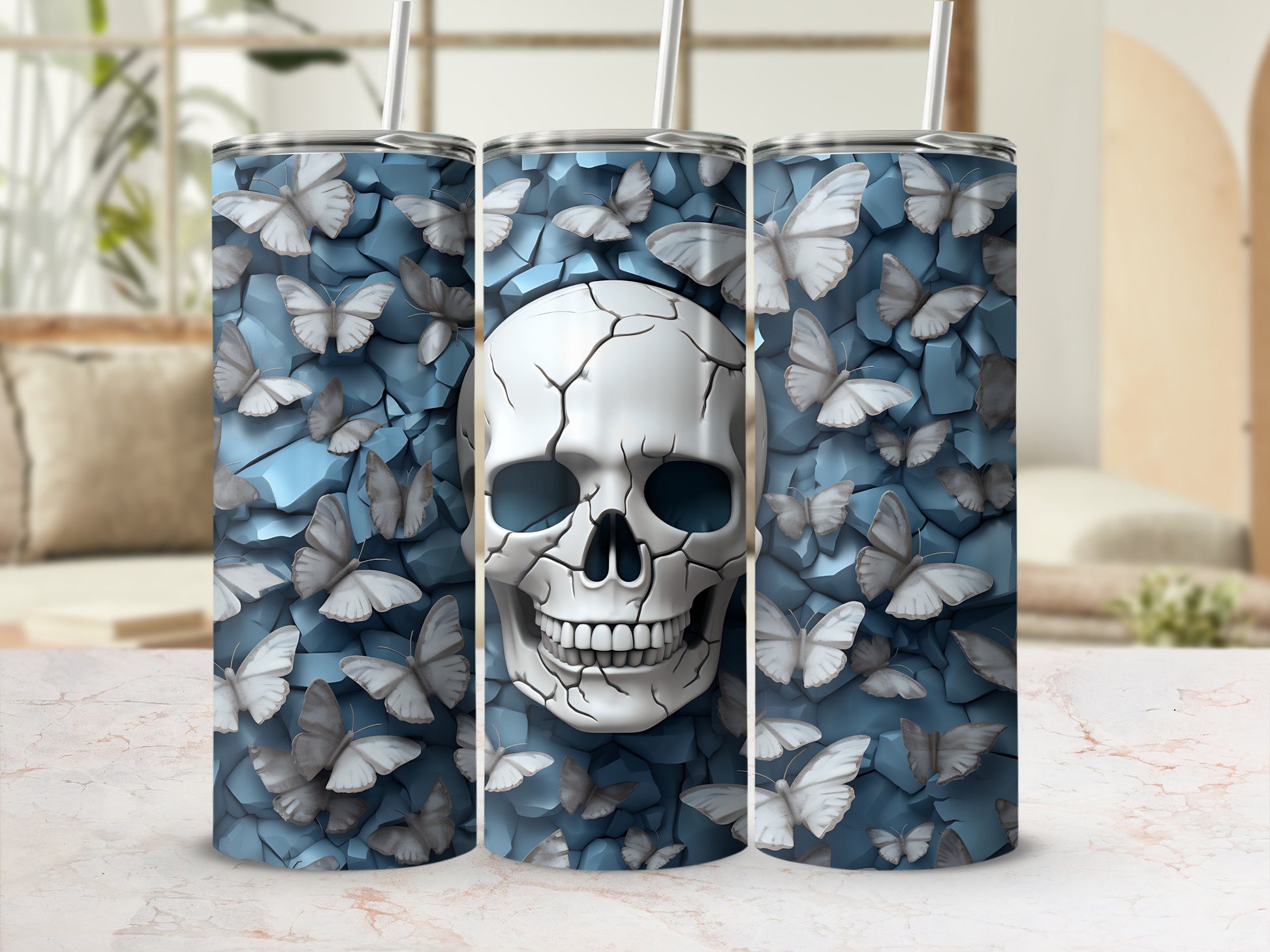 Three tumblers featuring a cracked skull surrounded by light blue butterflies on a textured background.