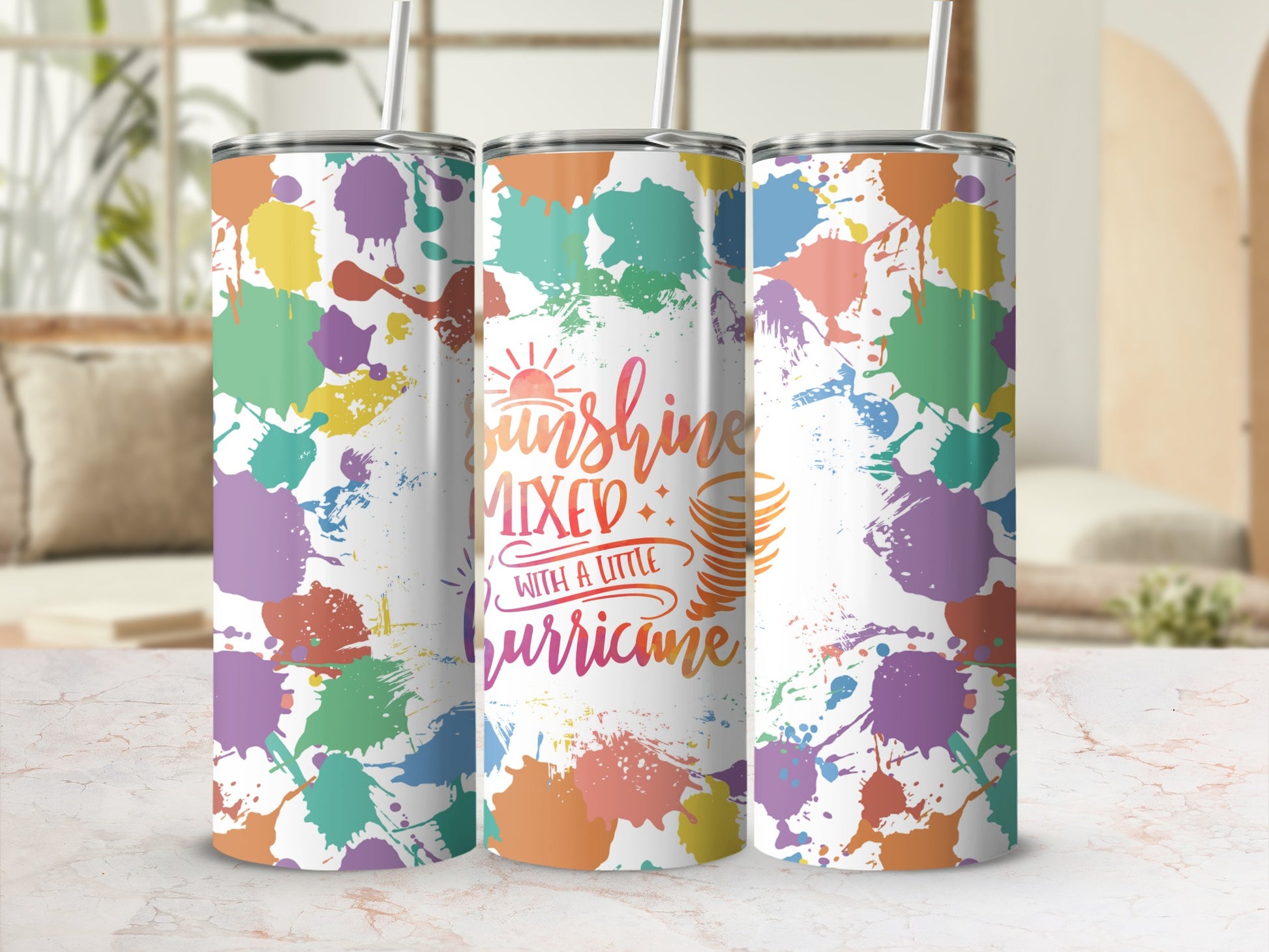 Three tumblers with a sunshine, mixed with a little hurricane design and colorful paint splatters.