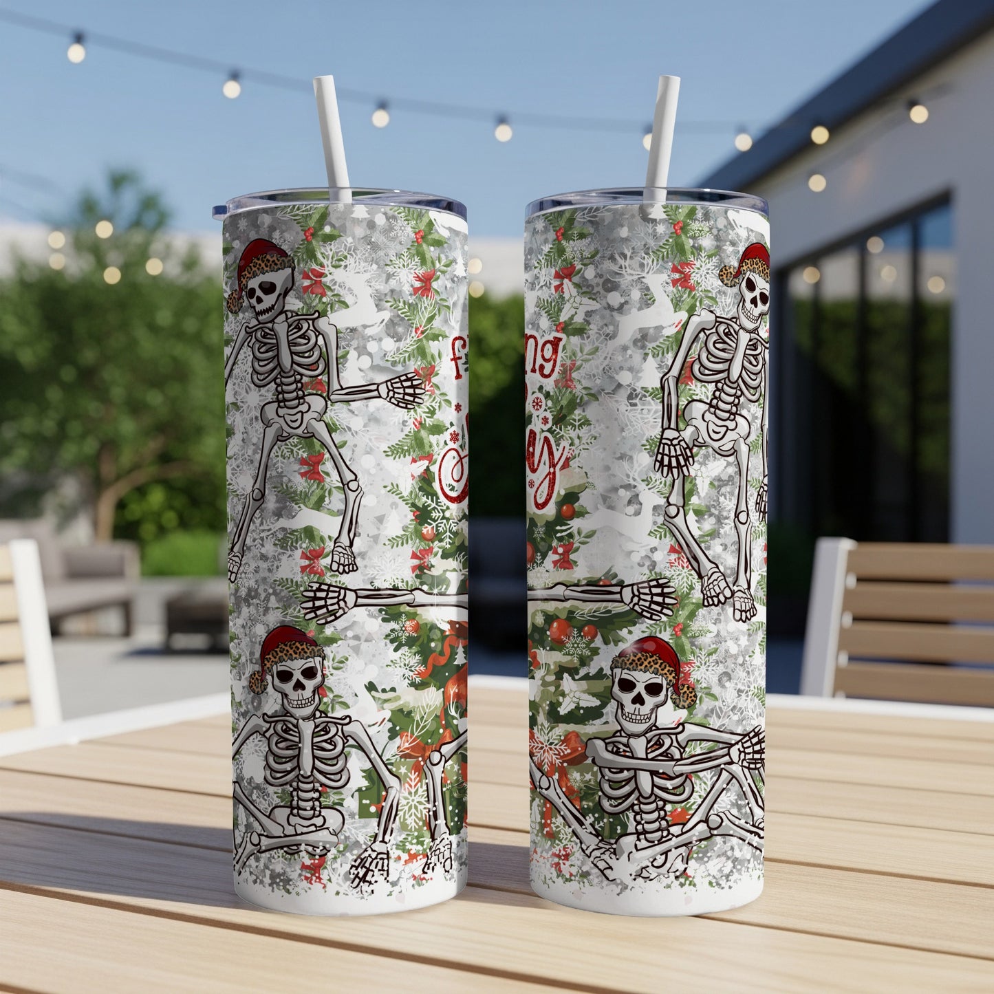Two skeleton tumblers with Christmas floral and "Merry" text.