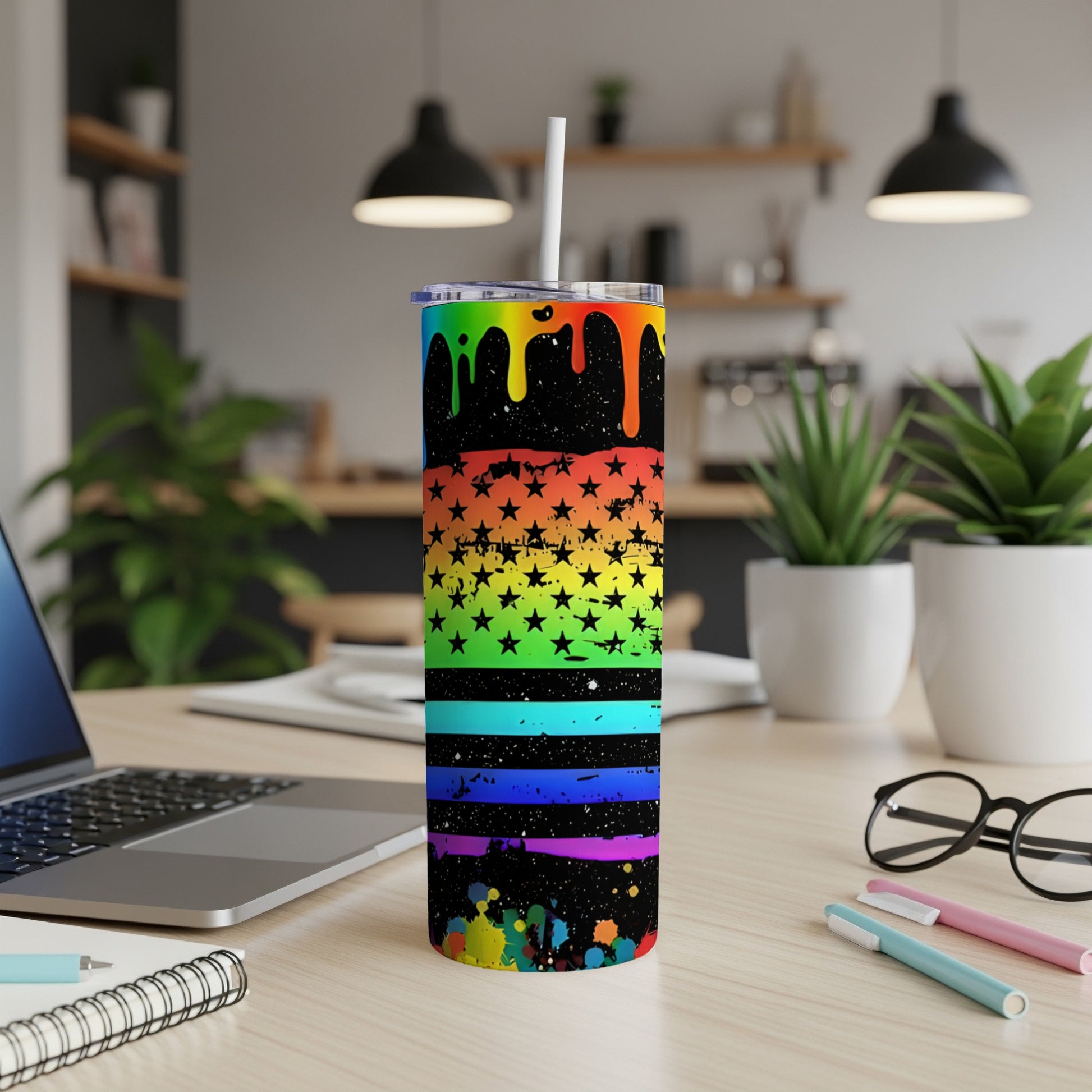 Black tumbler with rainbow-colored stars and stripes, a white straw.