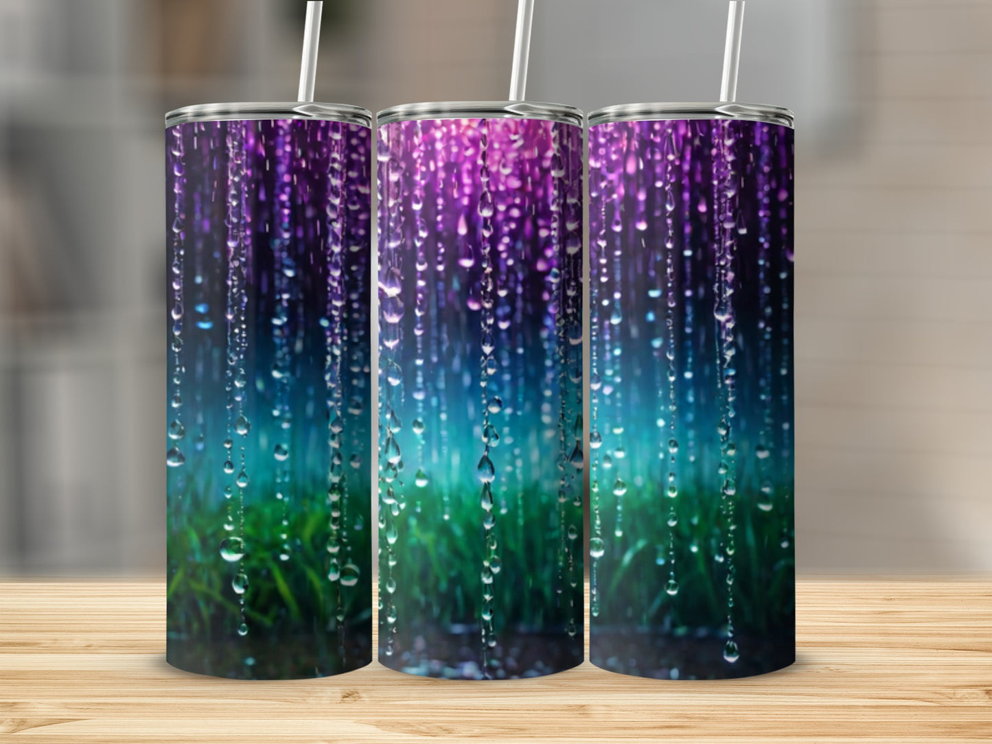 Three tumblers with a colorful abstract rain and grass design.