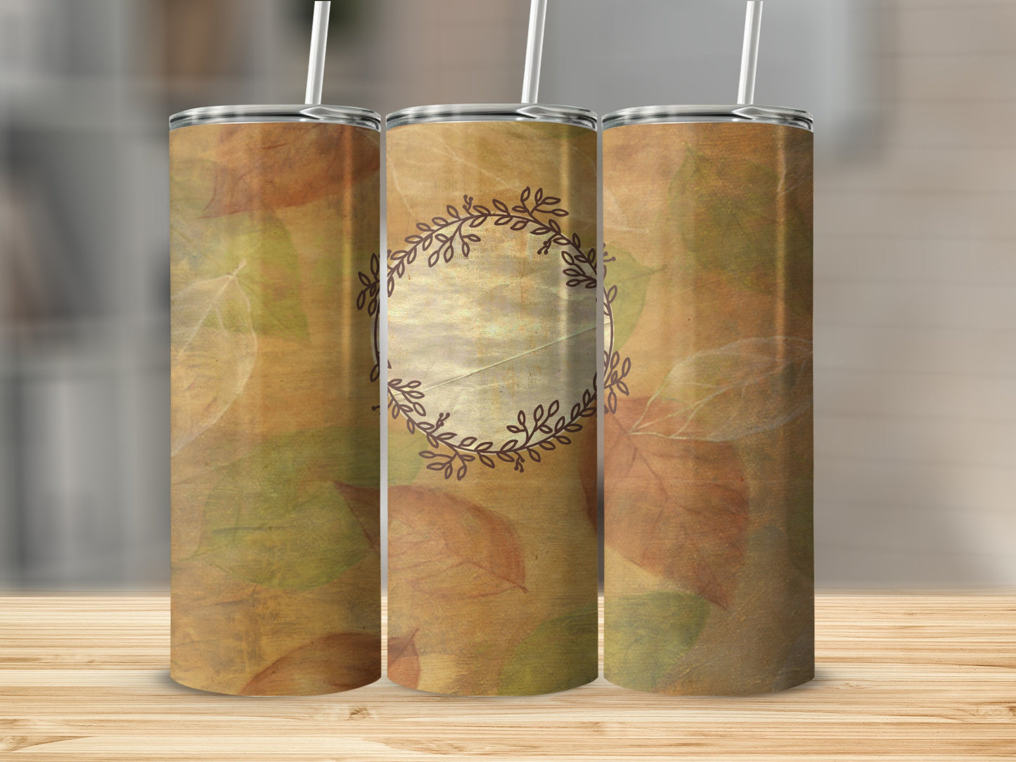 Three tumblers with autumn leaf pattern and central wreath design.