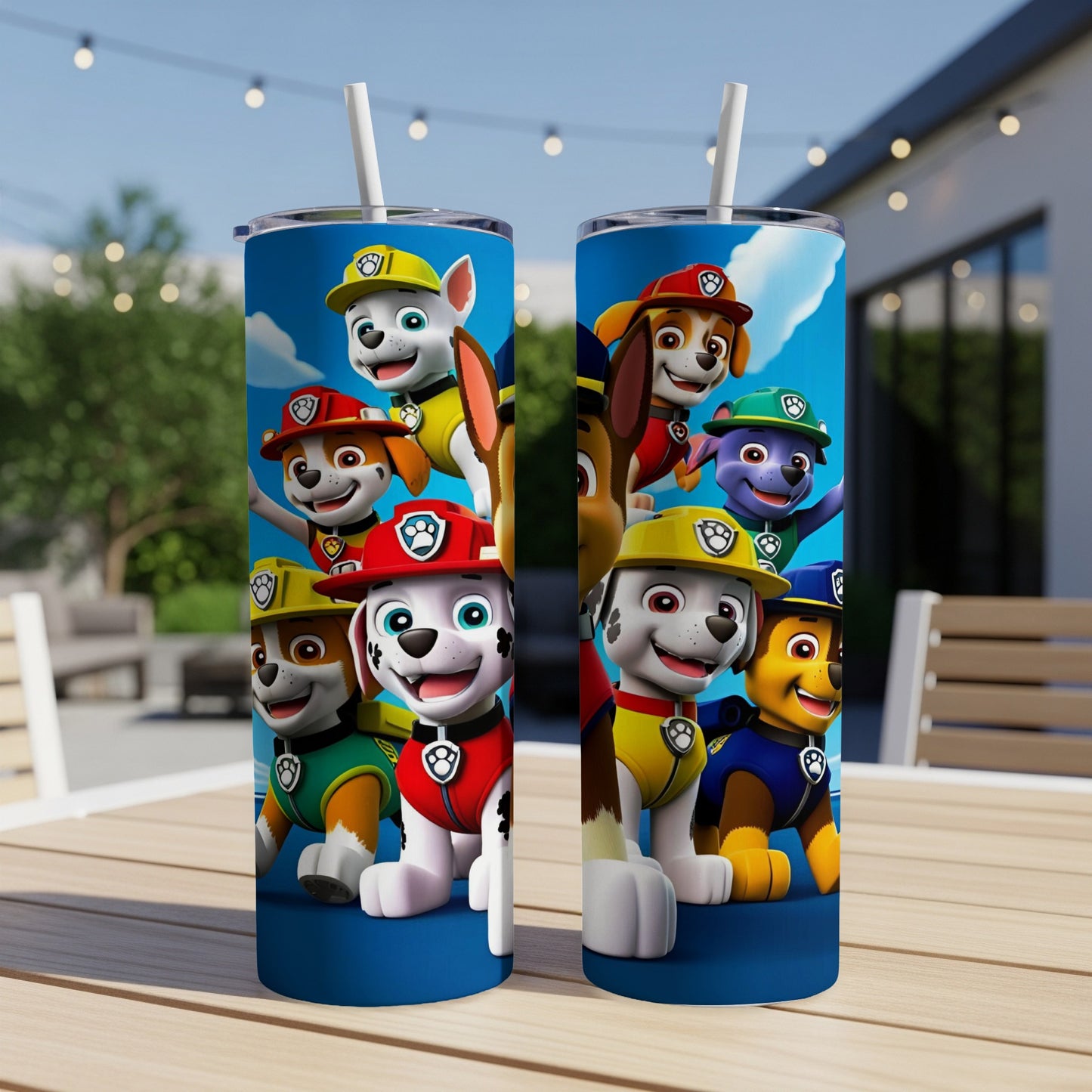 Two Paw Patrol tumblers with cartoon characters on a wooden table outdoors.