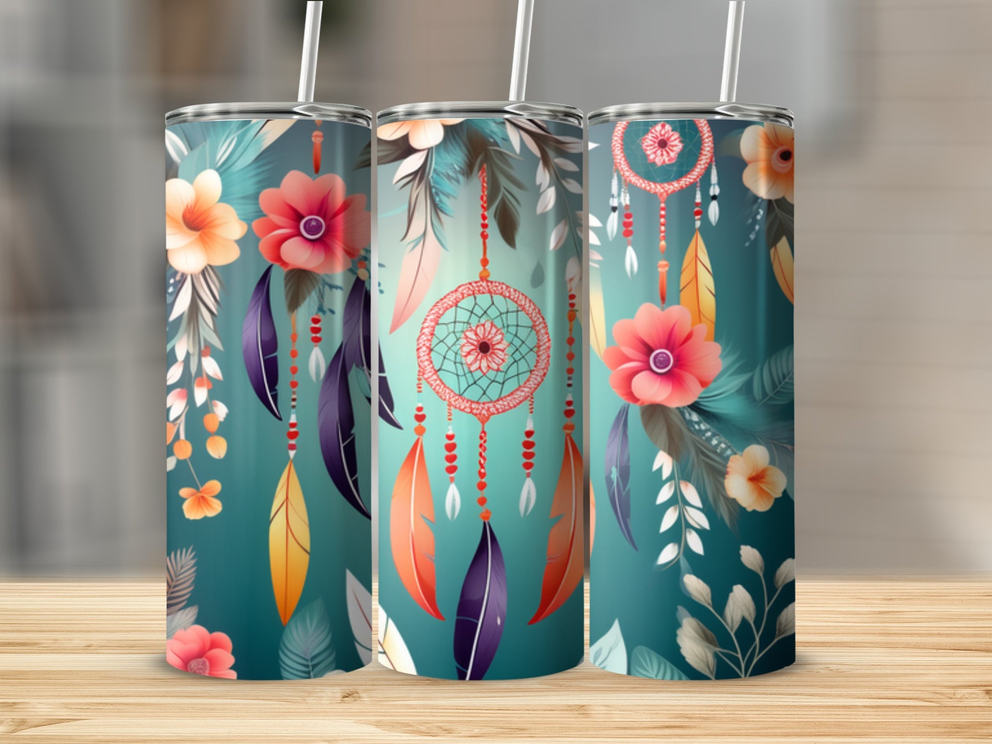 Three teal tumblers with dreamcatcher and floral designs, on a wooden surface.