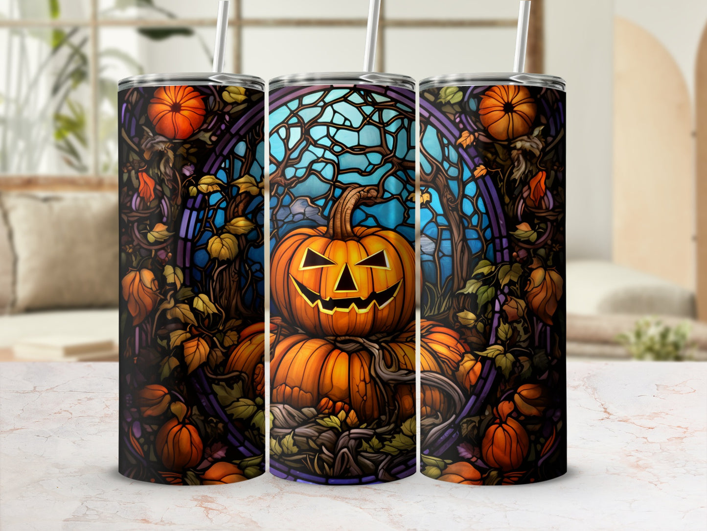 Three tumblers with a spooky pumpkin and autumn vine design.