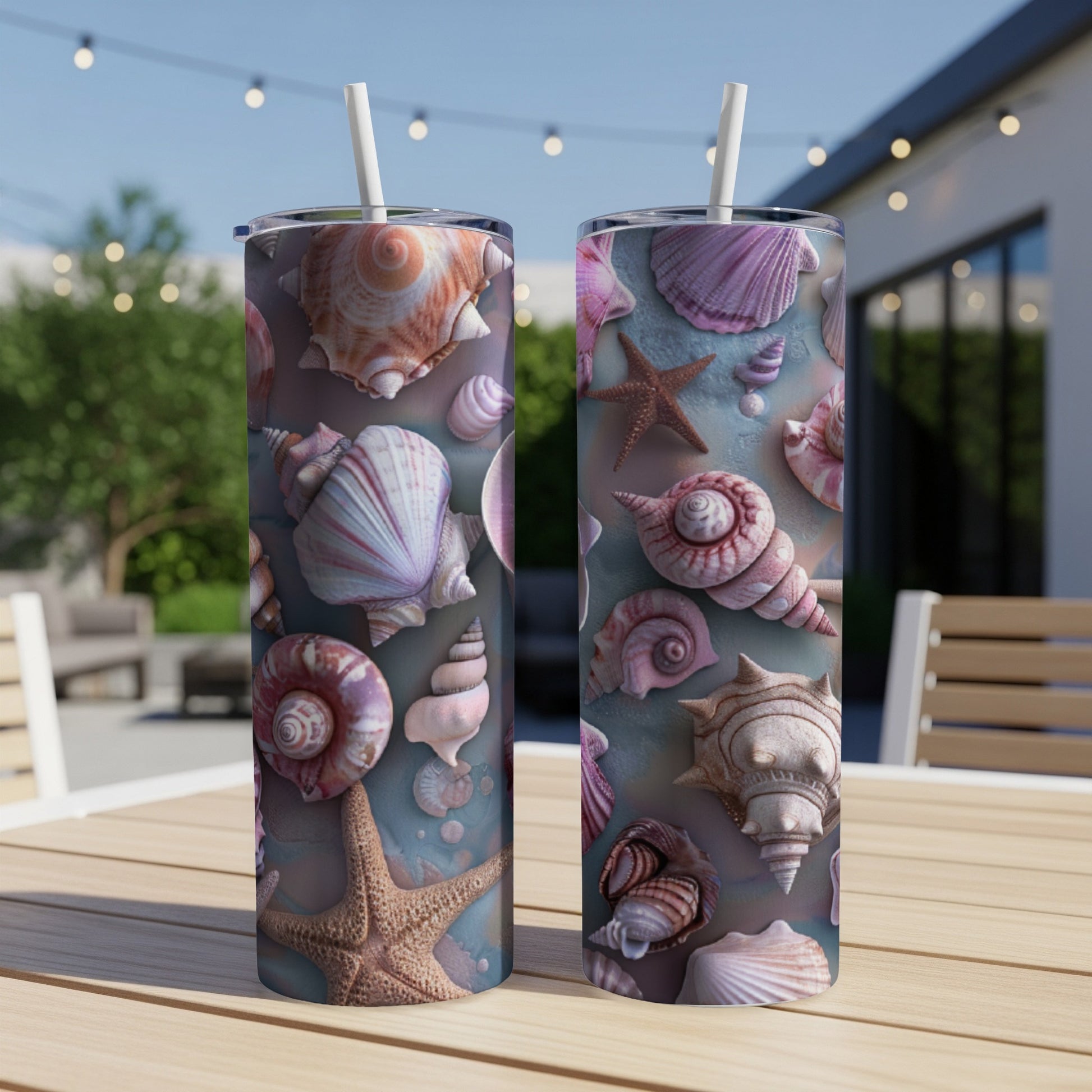 Two tall tumblers with a seashell pattern sit on a wooden table outdoors.