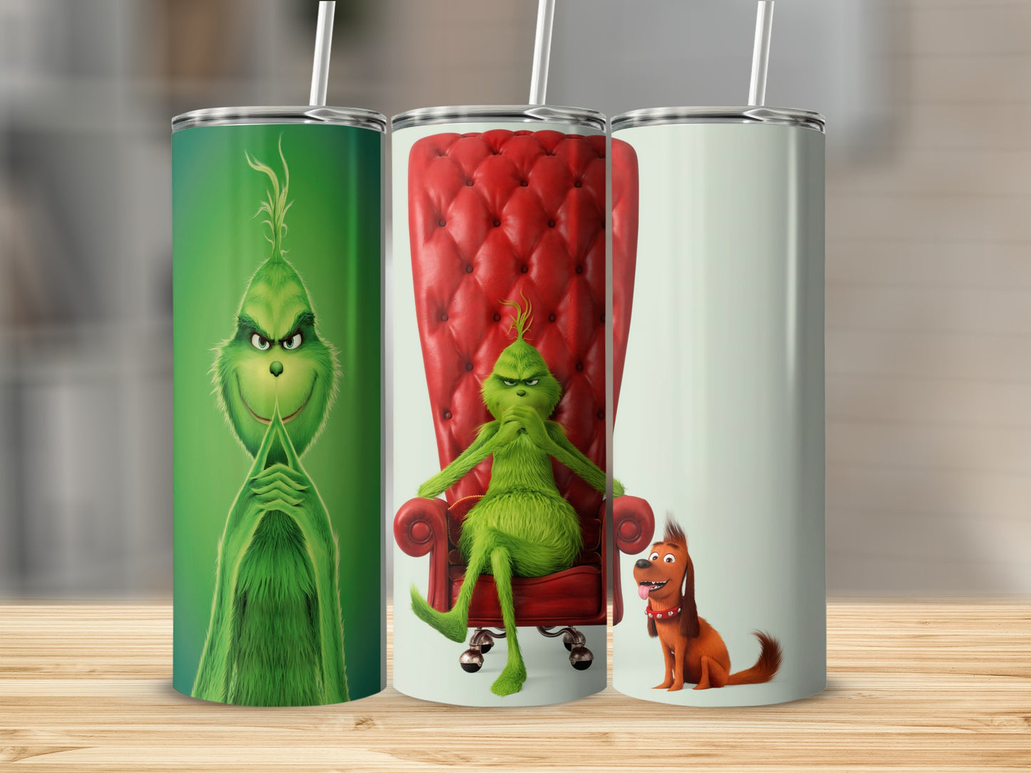 Three Grinch tumblers, one with the Grinch posing, one with the Grinch sitting in a red chair, and one with Max.