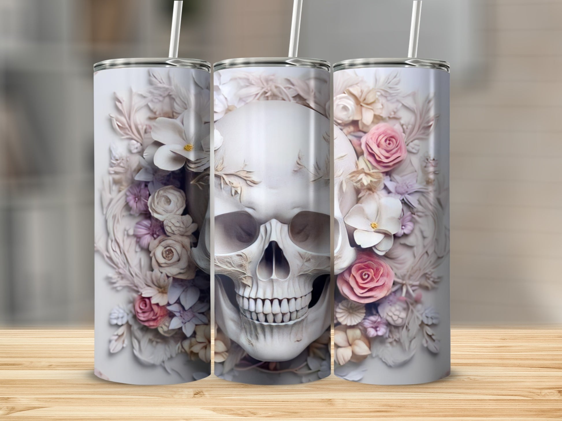 White tumbler with skull and floral decoration and straw.