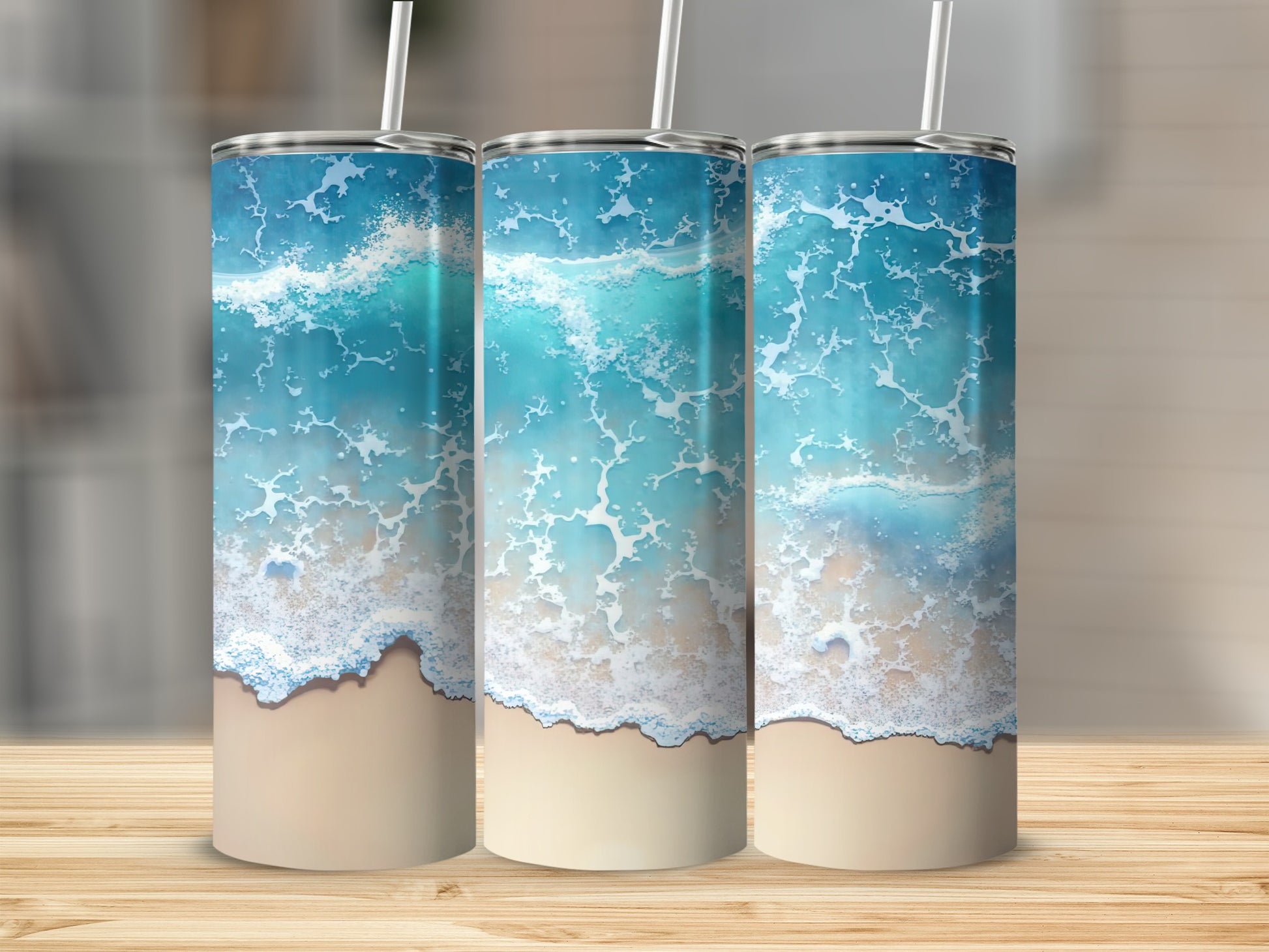 Three tumblers with a blue ocean wave and sand design.