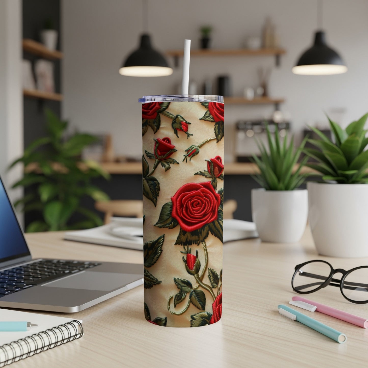 Red roses pattern on a white insulated tumbler with a straw.
