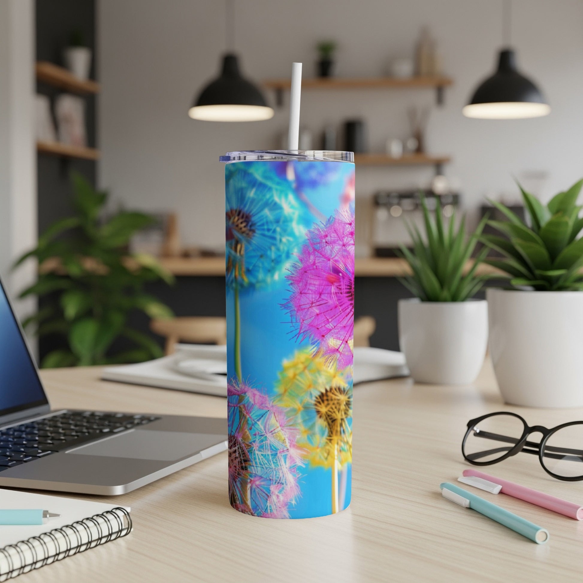 Tumbler with colorful dandelion puffballs against a bright blue background.