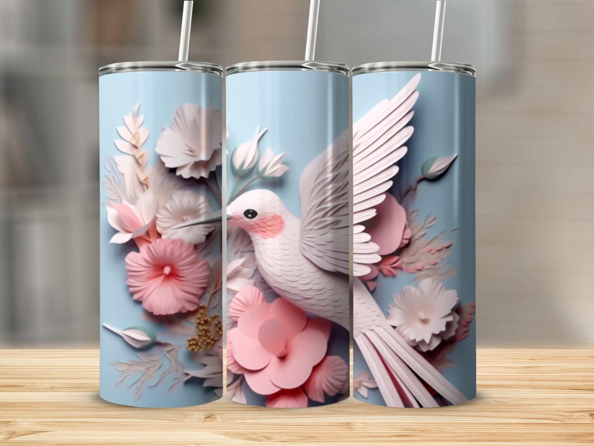 White bird with pink flowers on a light blue tumbler.