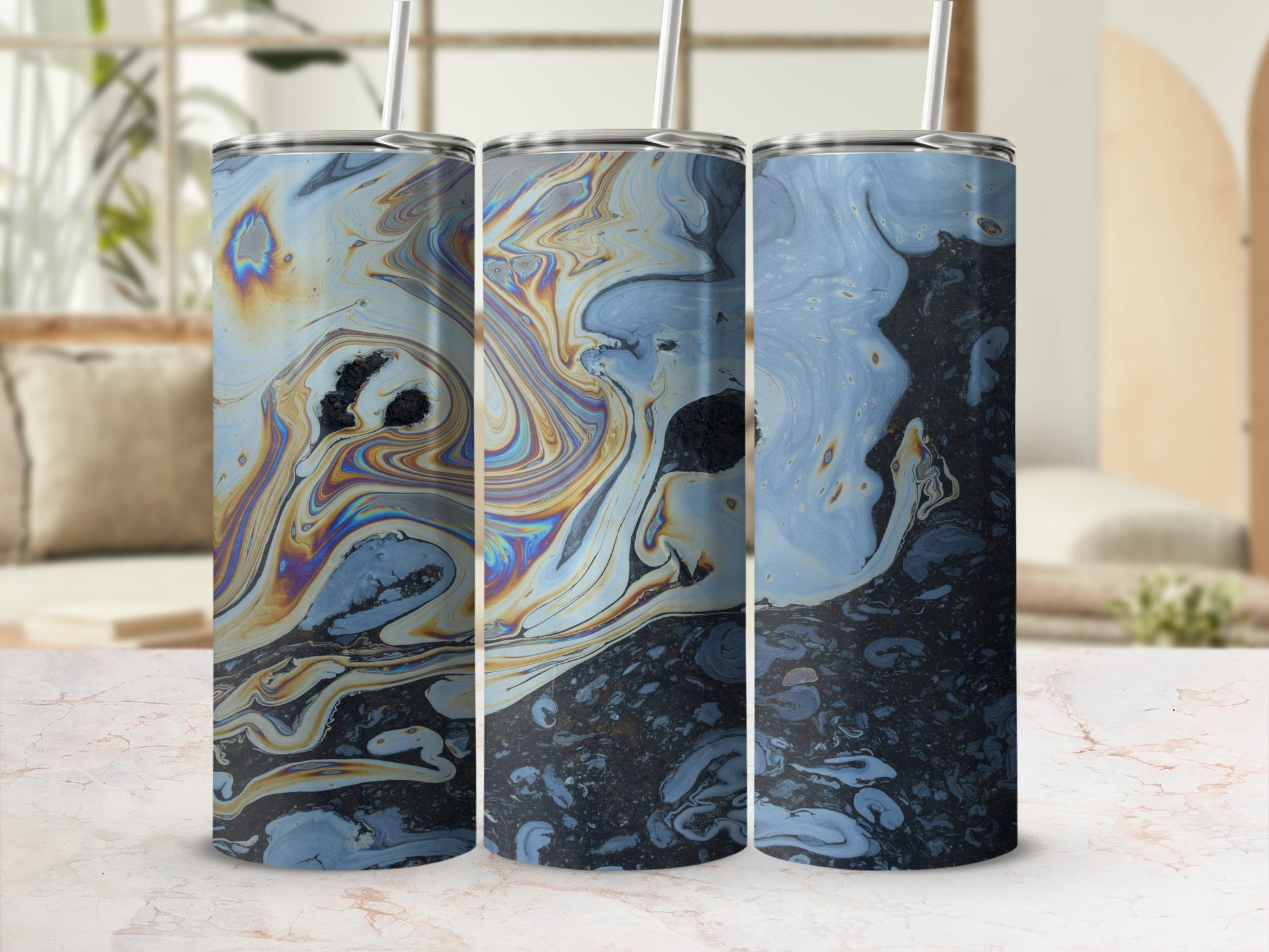 Three tumblers with a swirling iridescent oil-slick pattern, on a marble surface.