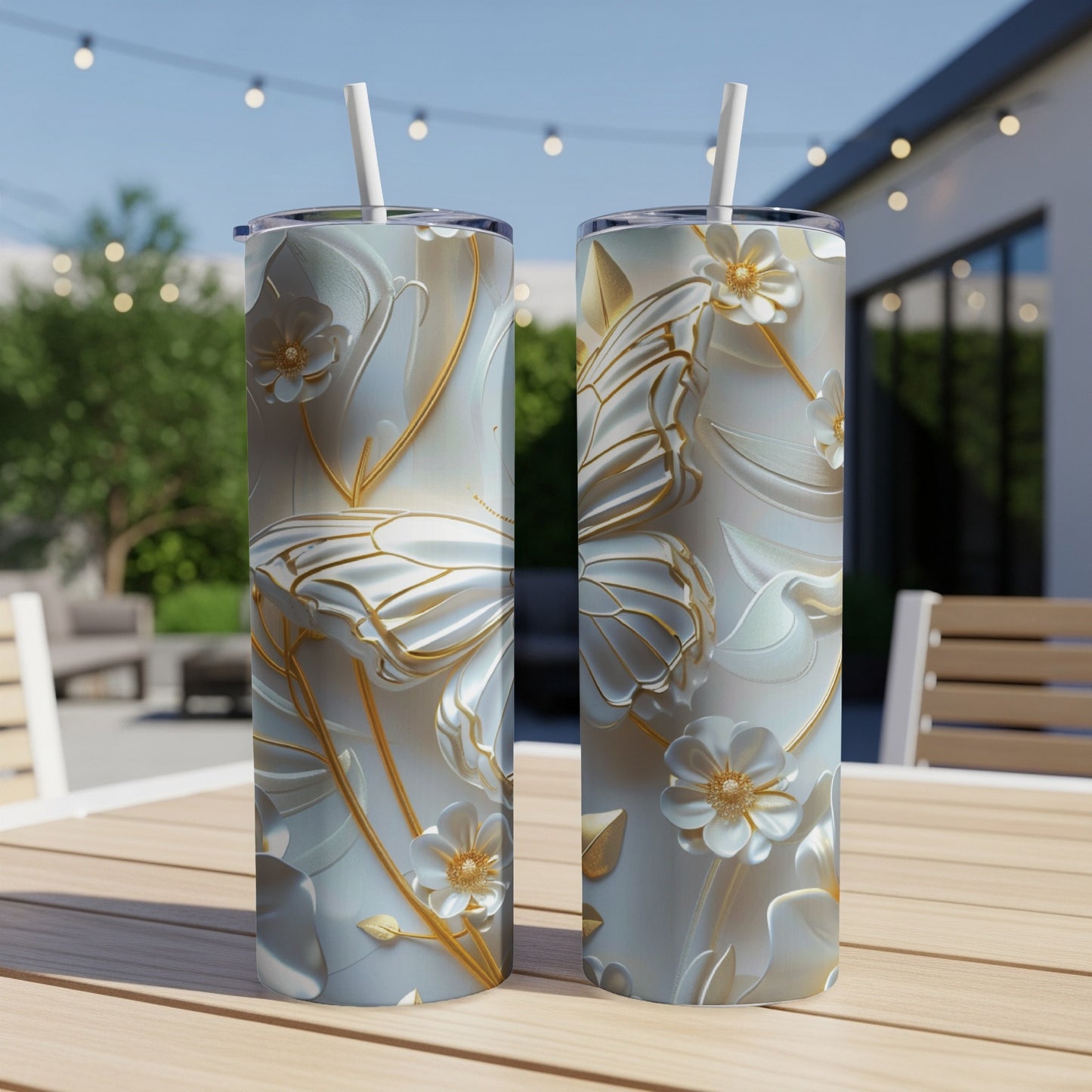 Two white tumblers with intricate gold butterfly and floral embossed designs.