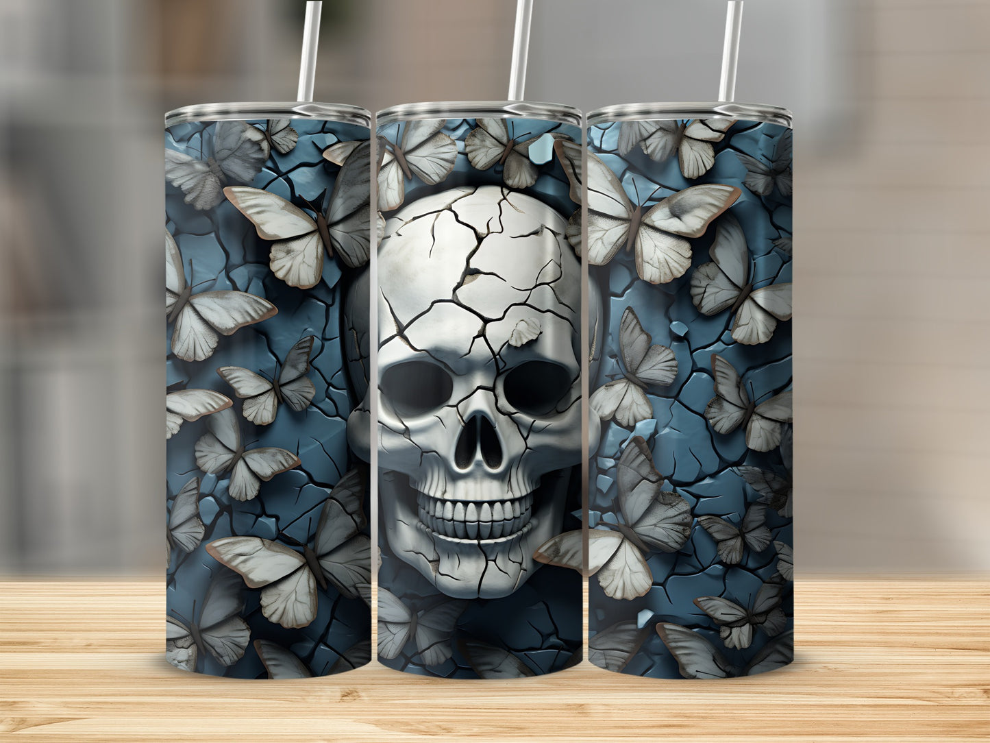 Three tumblers with a cracked skull and butterfly design.