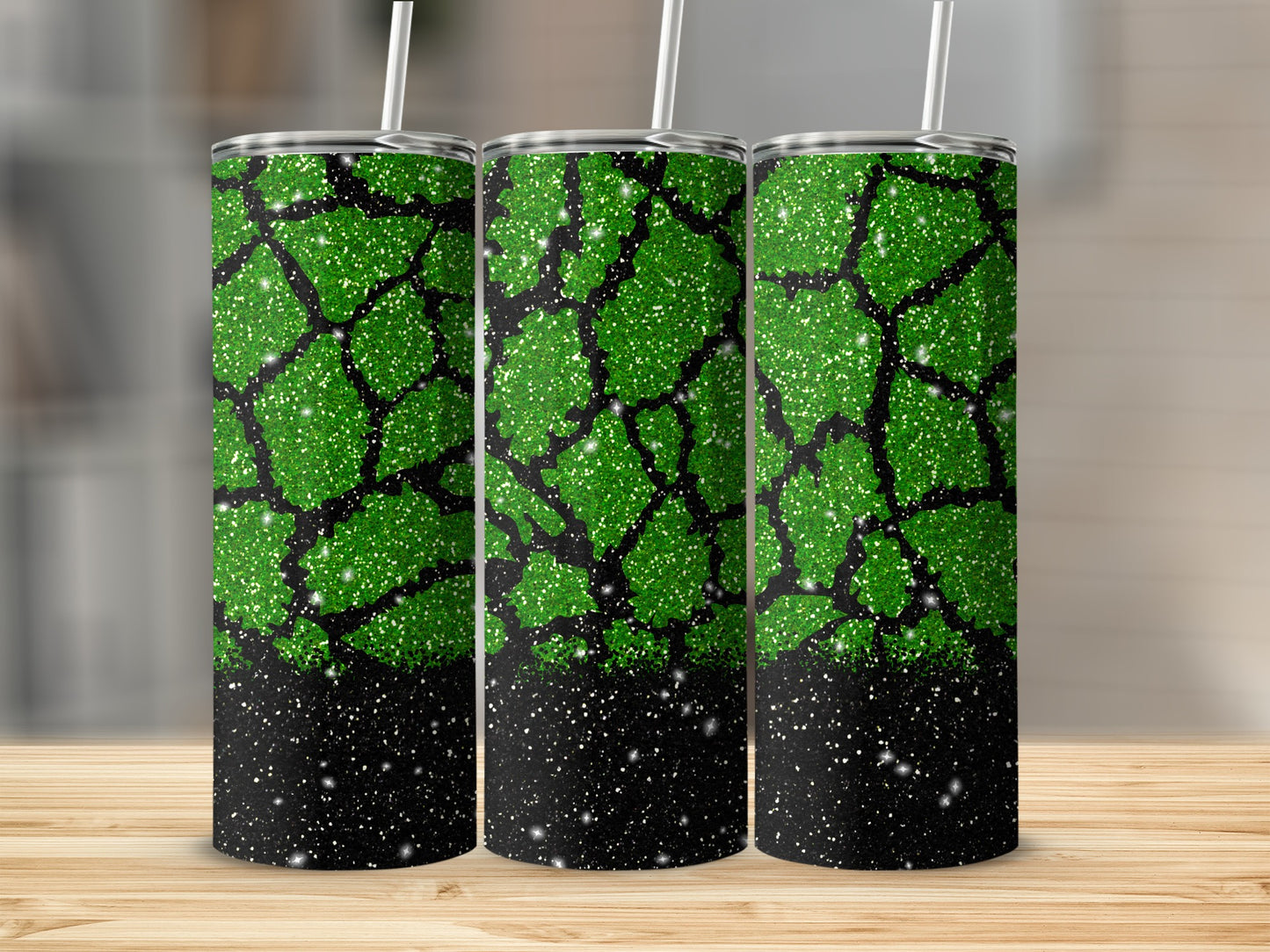 Green glitter tumbler with black crackle pattern and white straw.