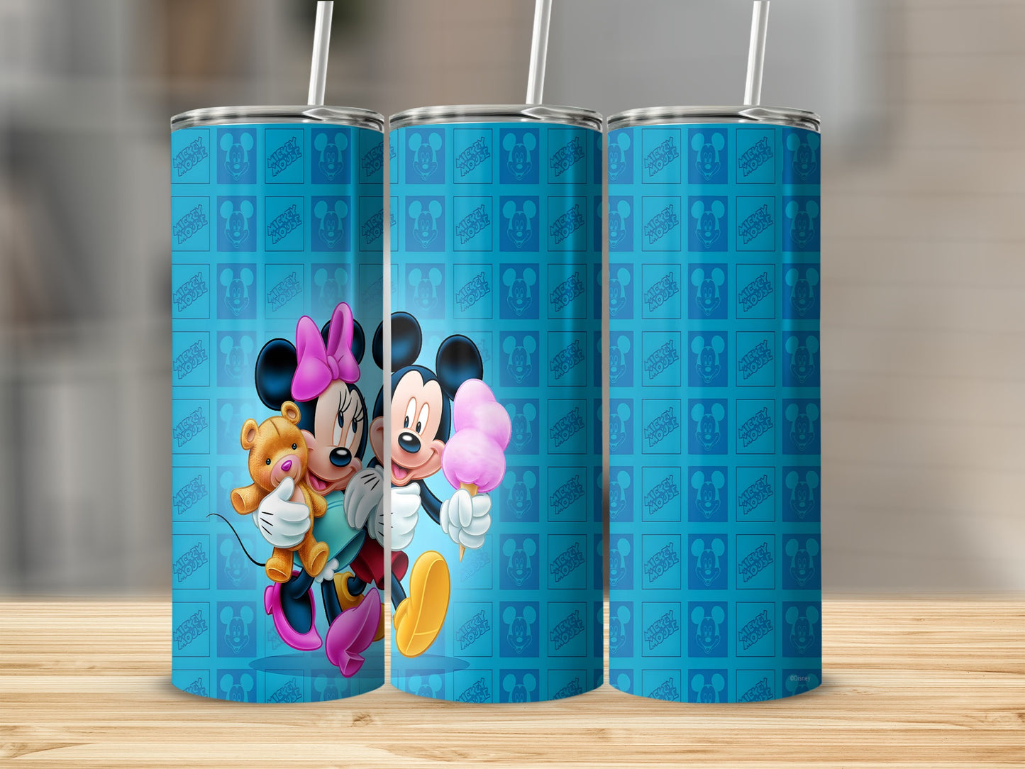 Mickey and Minnie Mouse with teddy bear on blue tumbler with repeating Mickey Mouse pattern.