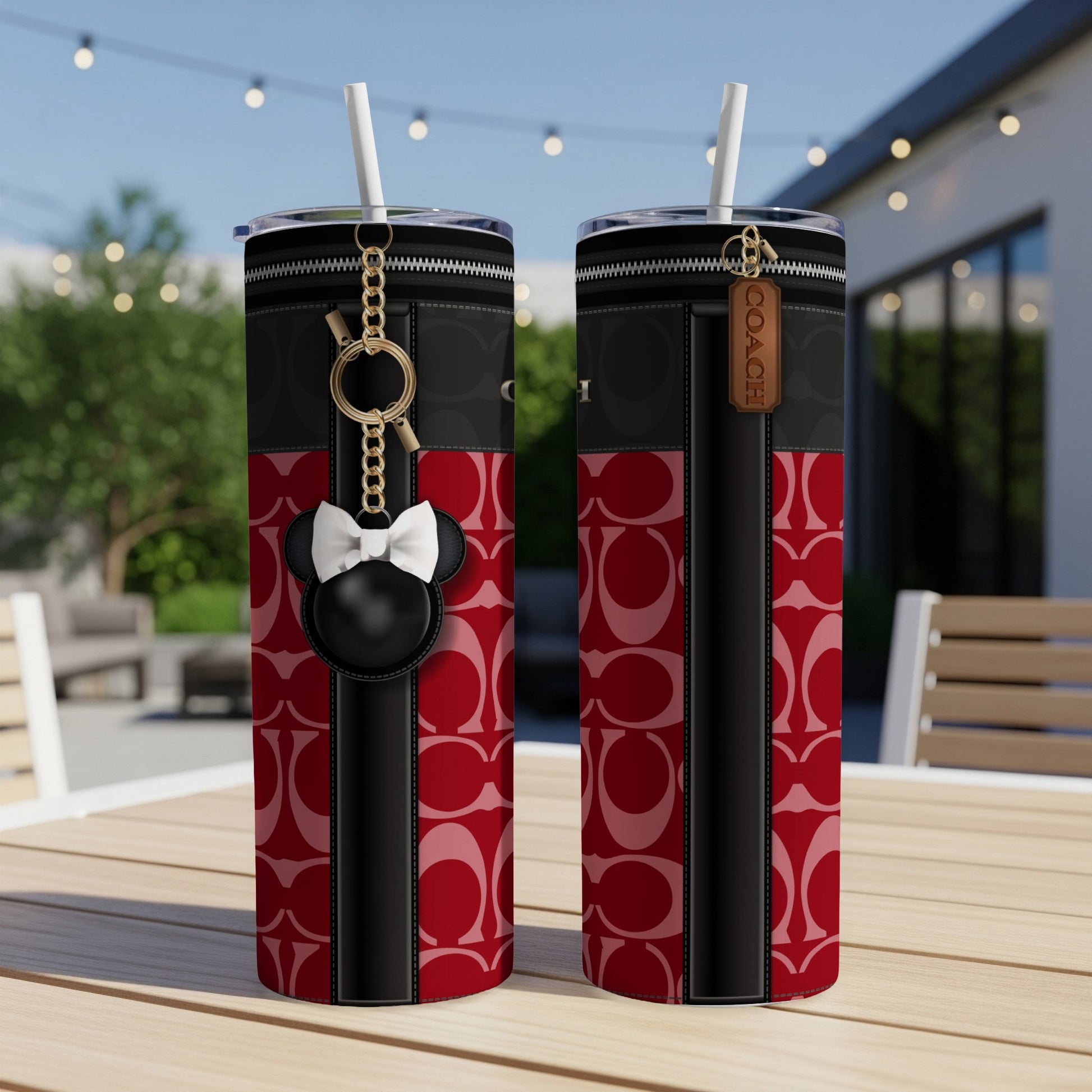 Two tumblers with red Coach pattern, black accents, and a Minnie Mouse charm.