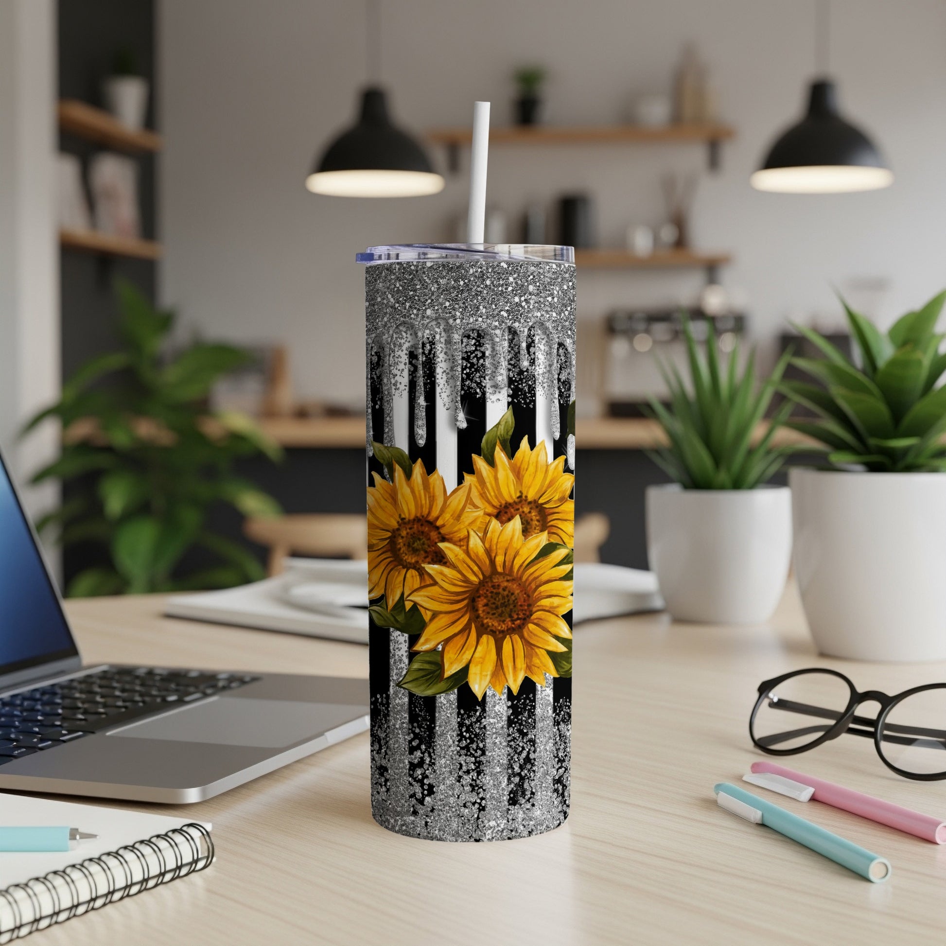 Silver glitter dripping down black stripes, with three sunflowers.