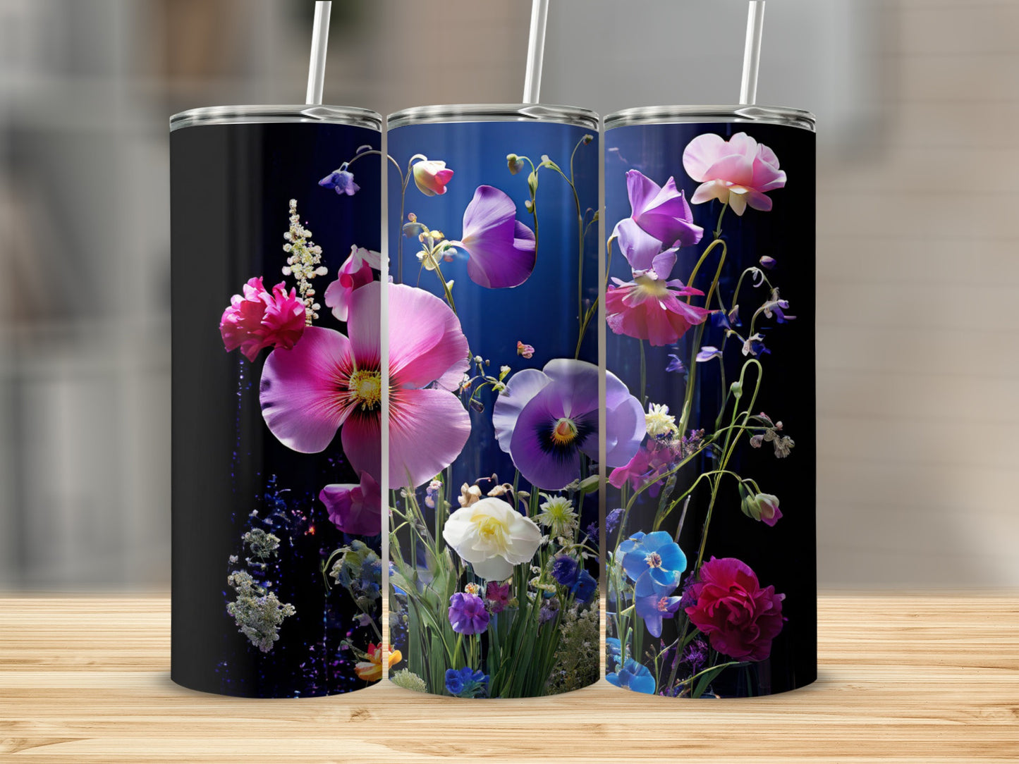 Three tumblers with vibrant floral artwork featuring pink, purple, and blue flowers.