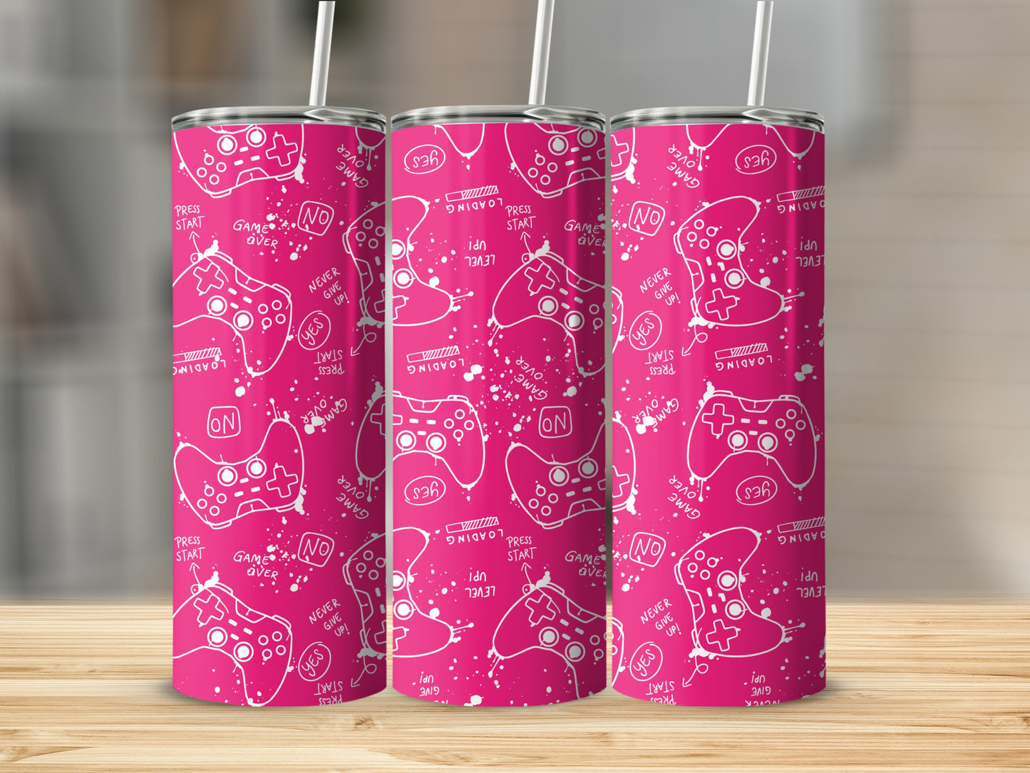 Pink video game controller pattern on three tumblers with text.