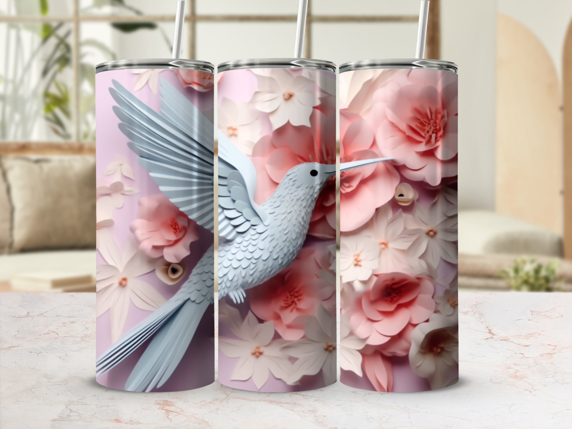 White hummingbird among pink and white floral patterns on a tumbler.