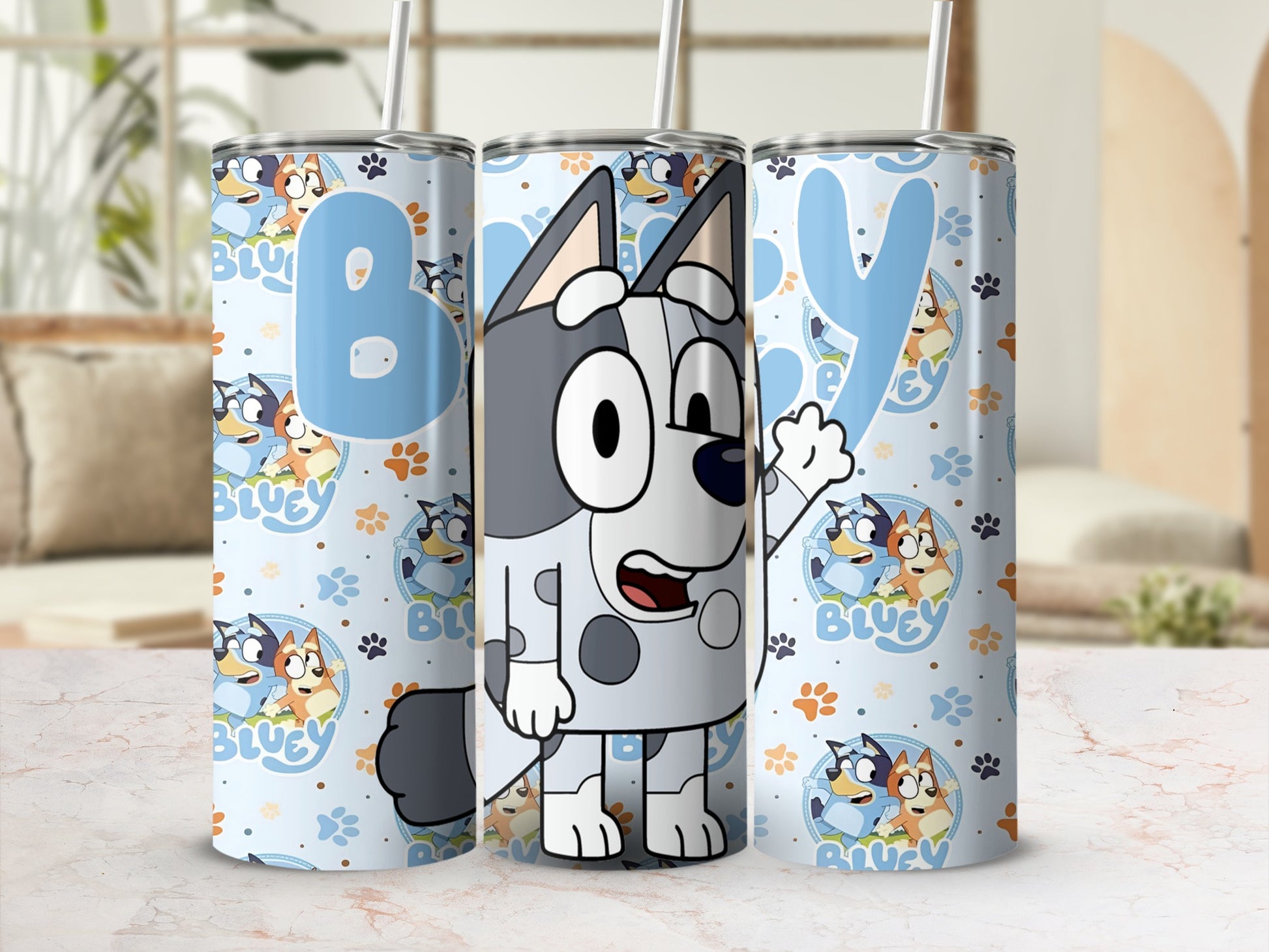 Bluey and Bingo cartoon characters on a light blue patterned tumbler.