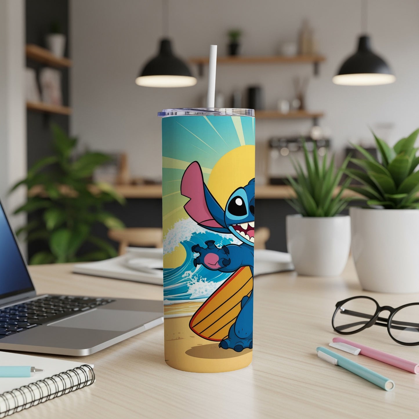 Stitch with surfboard on beach, standing by a laptop on a desk.