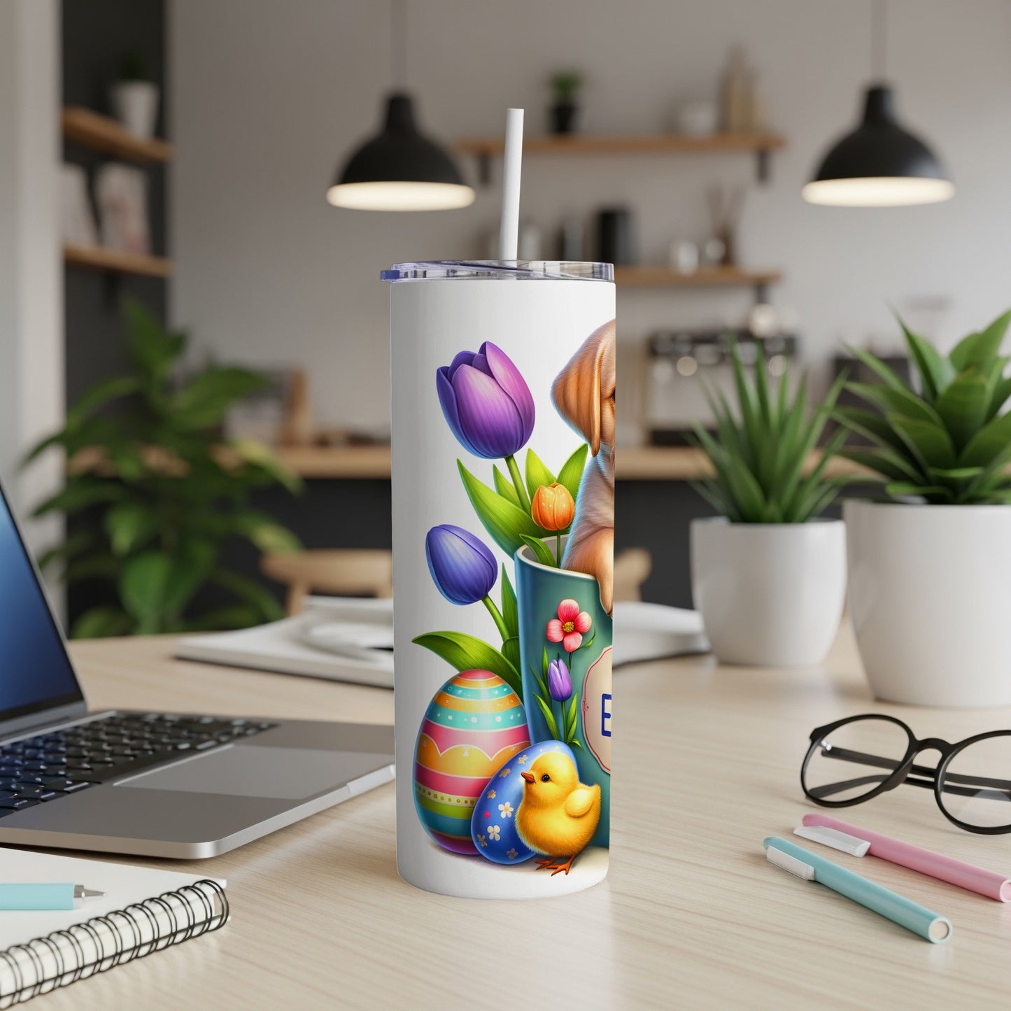 Easter tumbler with puppy, tulips, and decorated eggs on a desk.