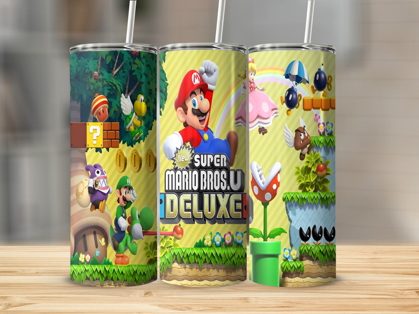Super Mario Bros. U Deluxe game art on three tumblers with Mario, Luigi, and Peach.