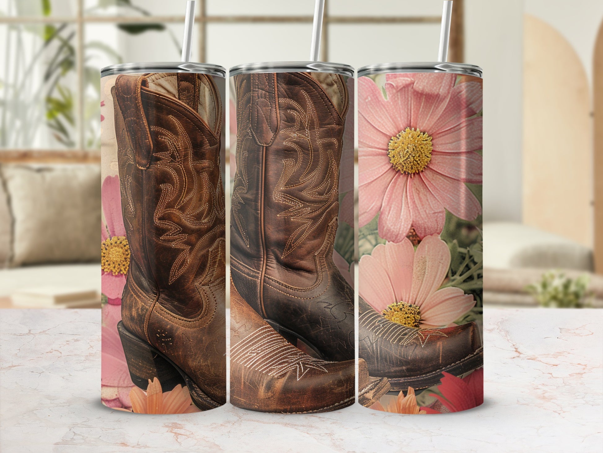 Cowboy boots and pink flowers on a marble surface with straws.