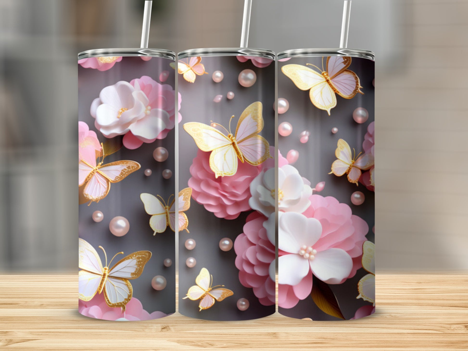 Pink and white flowers and butterflies adorn a gray tumbler.