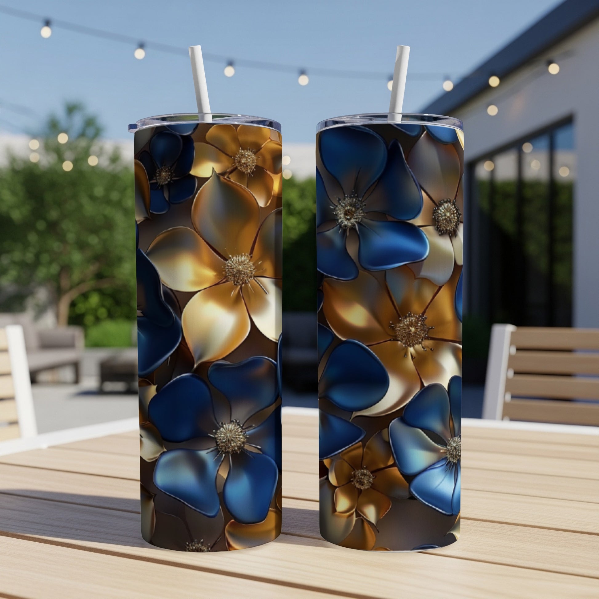 Two tumblers with a blue and gold floral pattern sit on a table.