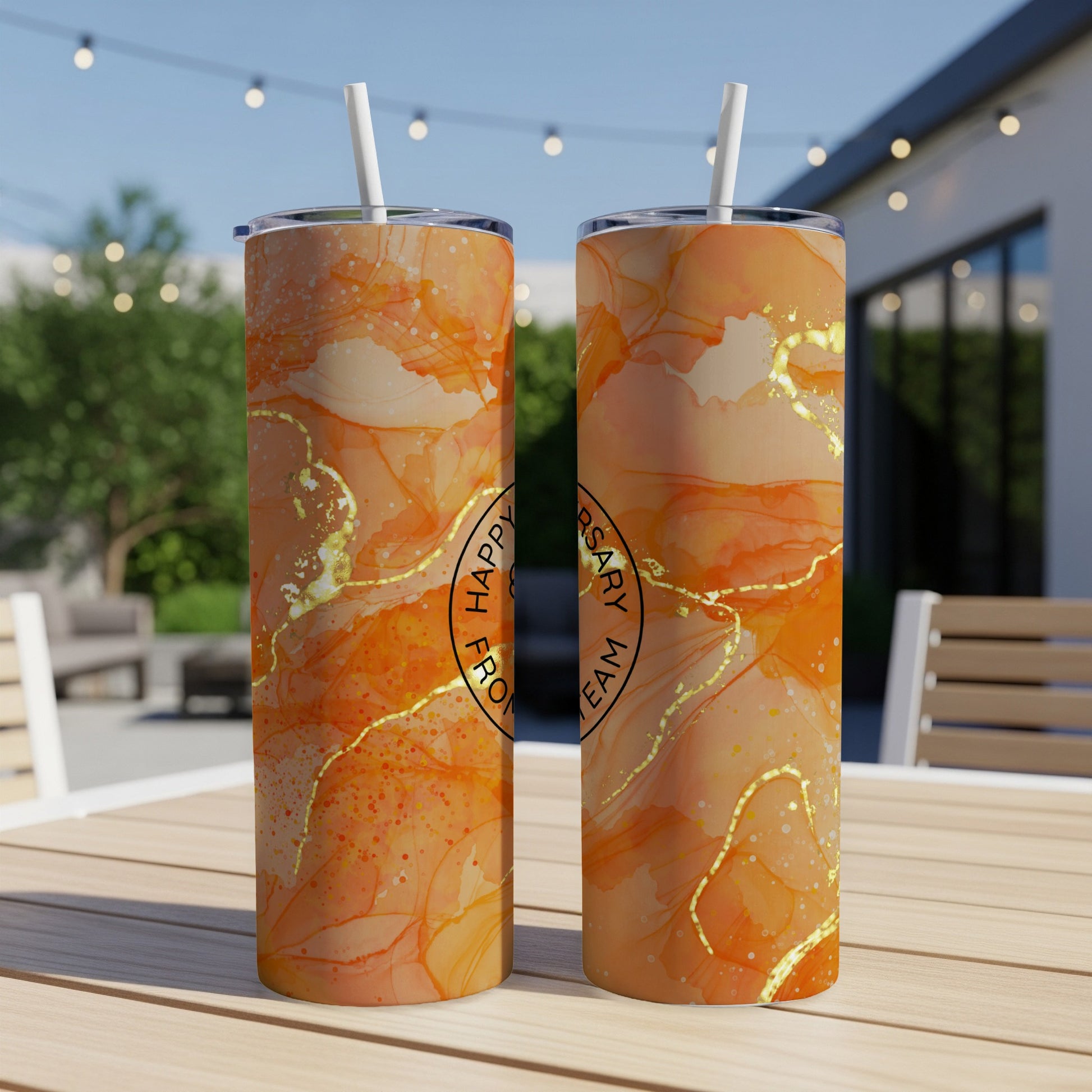 Two orange marble patterned tumblers with gold accents and text.