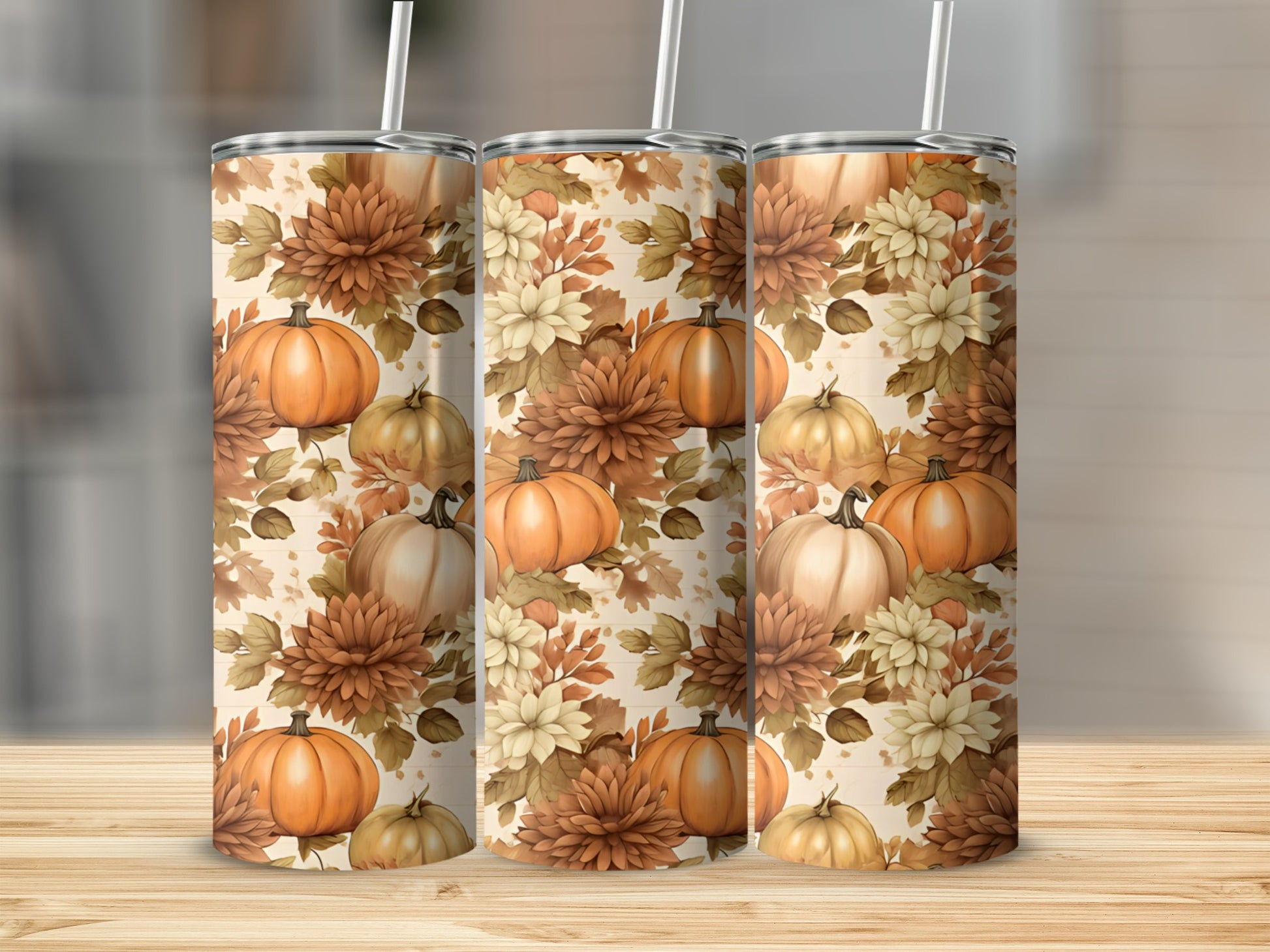 Three tumblers with a pumpkin and floral fall-themed pattern.