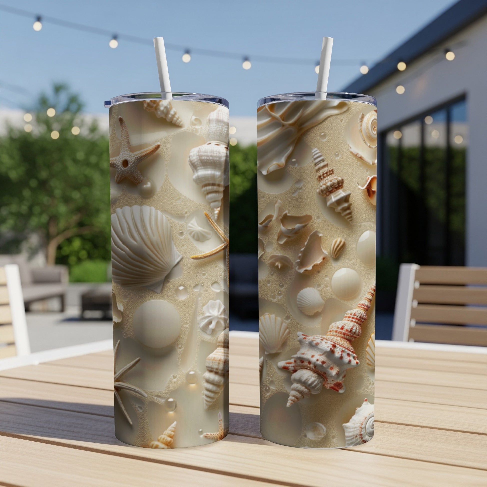 Two tumblers decorated with detailed seashell and sand patterns.