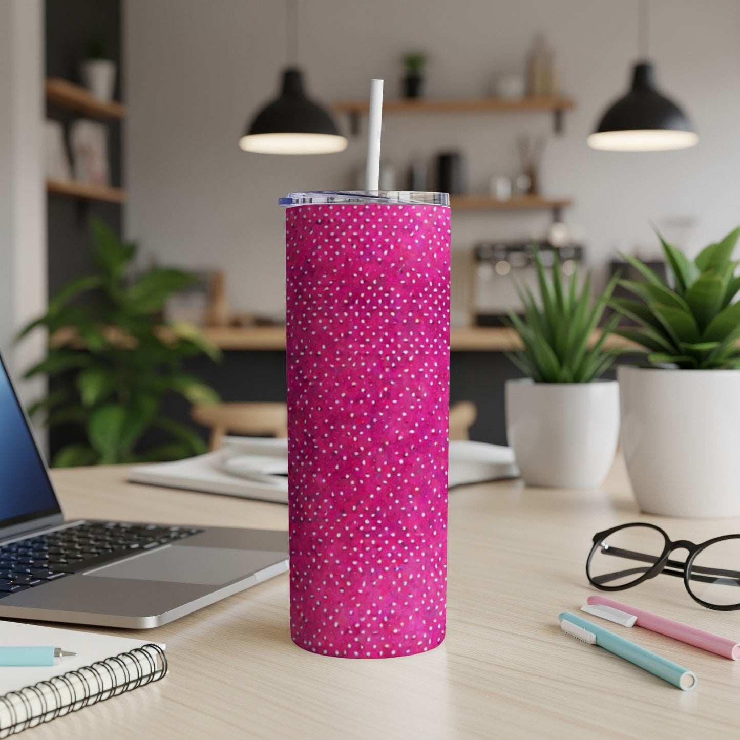 Pink tumbler with white polka dots and a white straw.