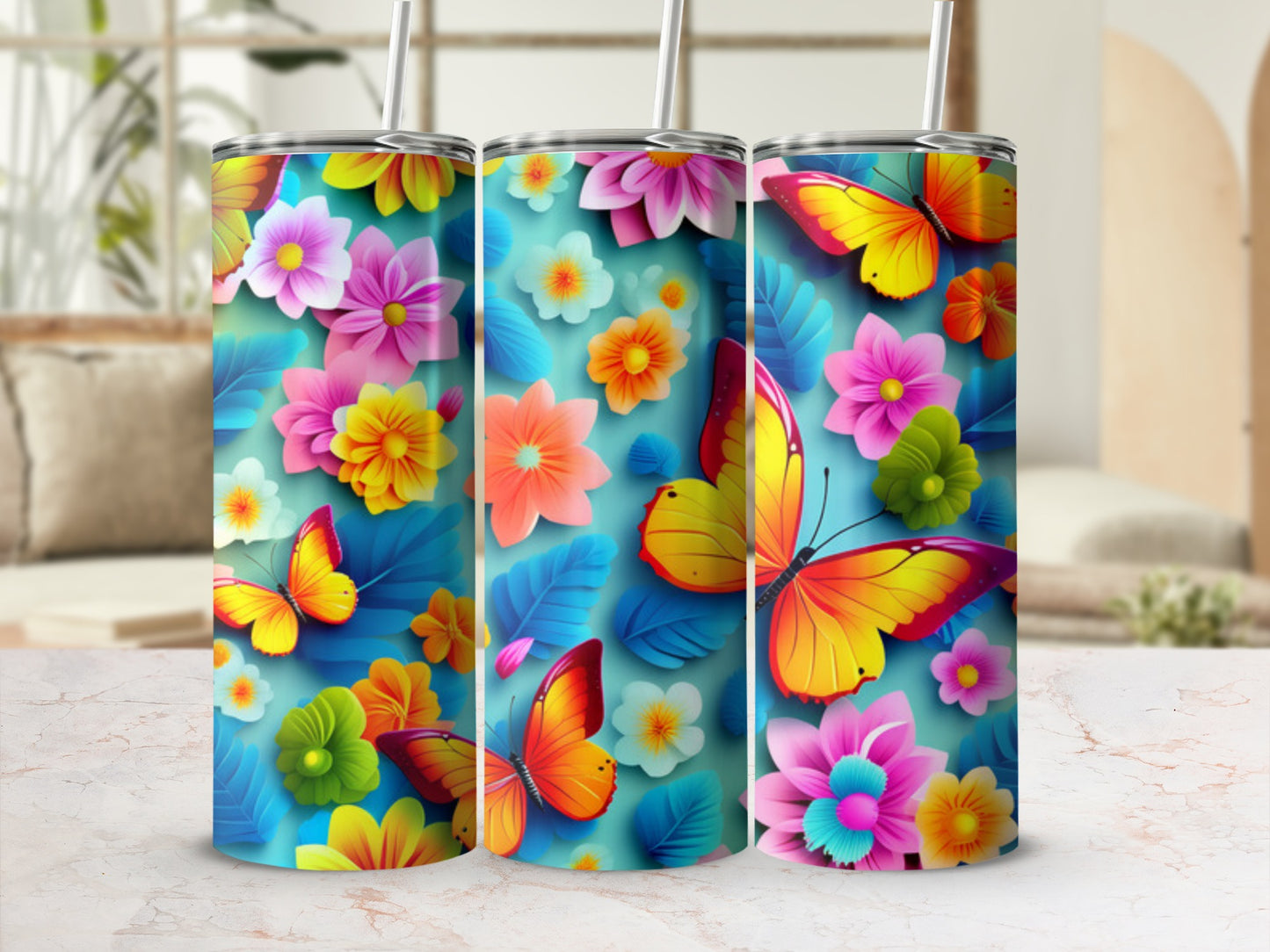 Three colorful tumblers with floral and butterfly designs.
