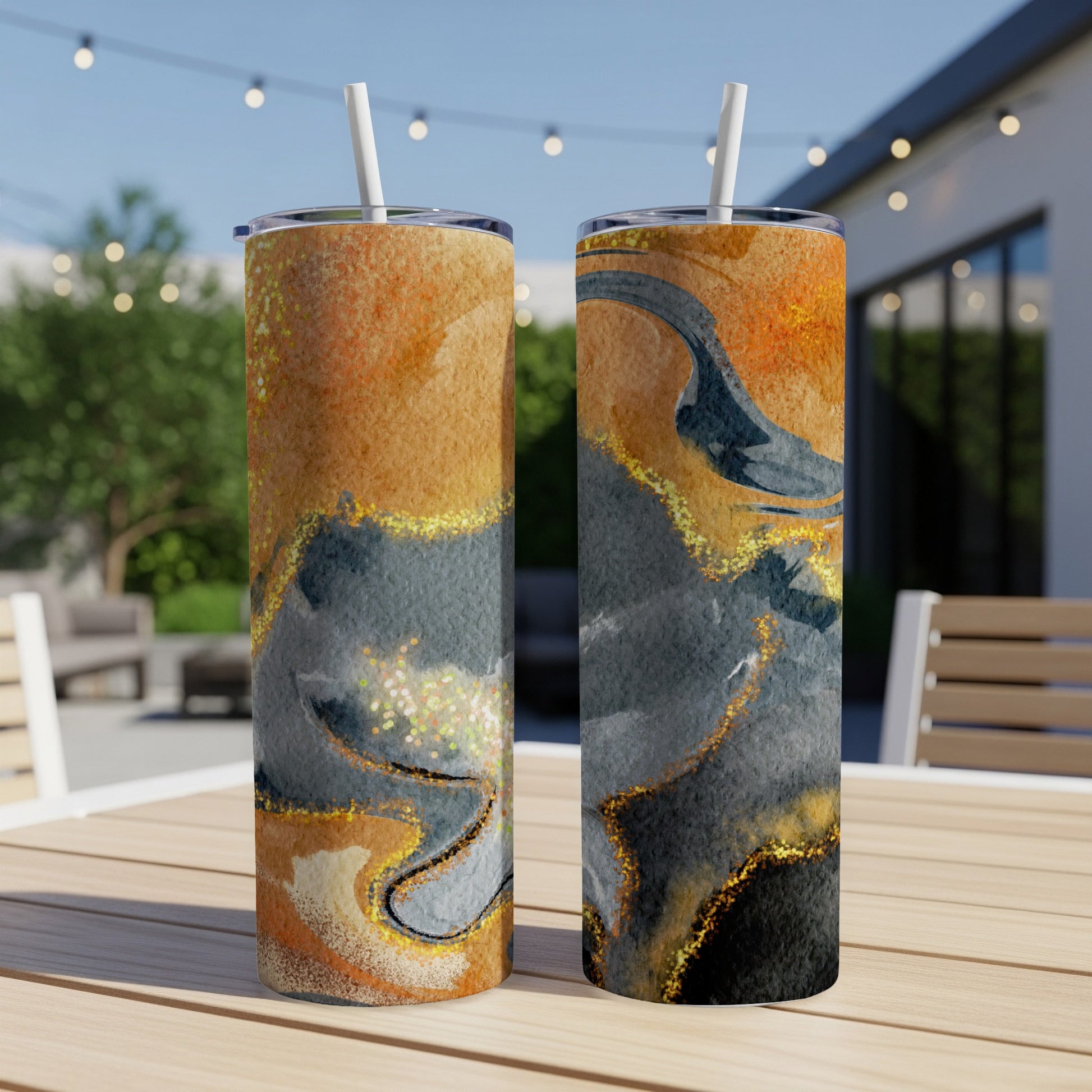 Two tumblers with marbled orange, gold, and gray abstract design.