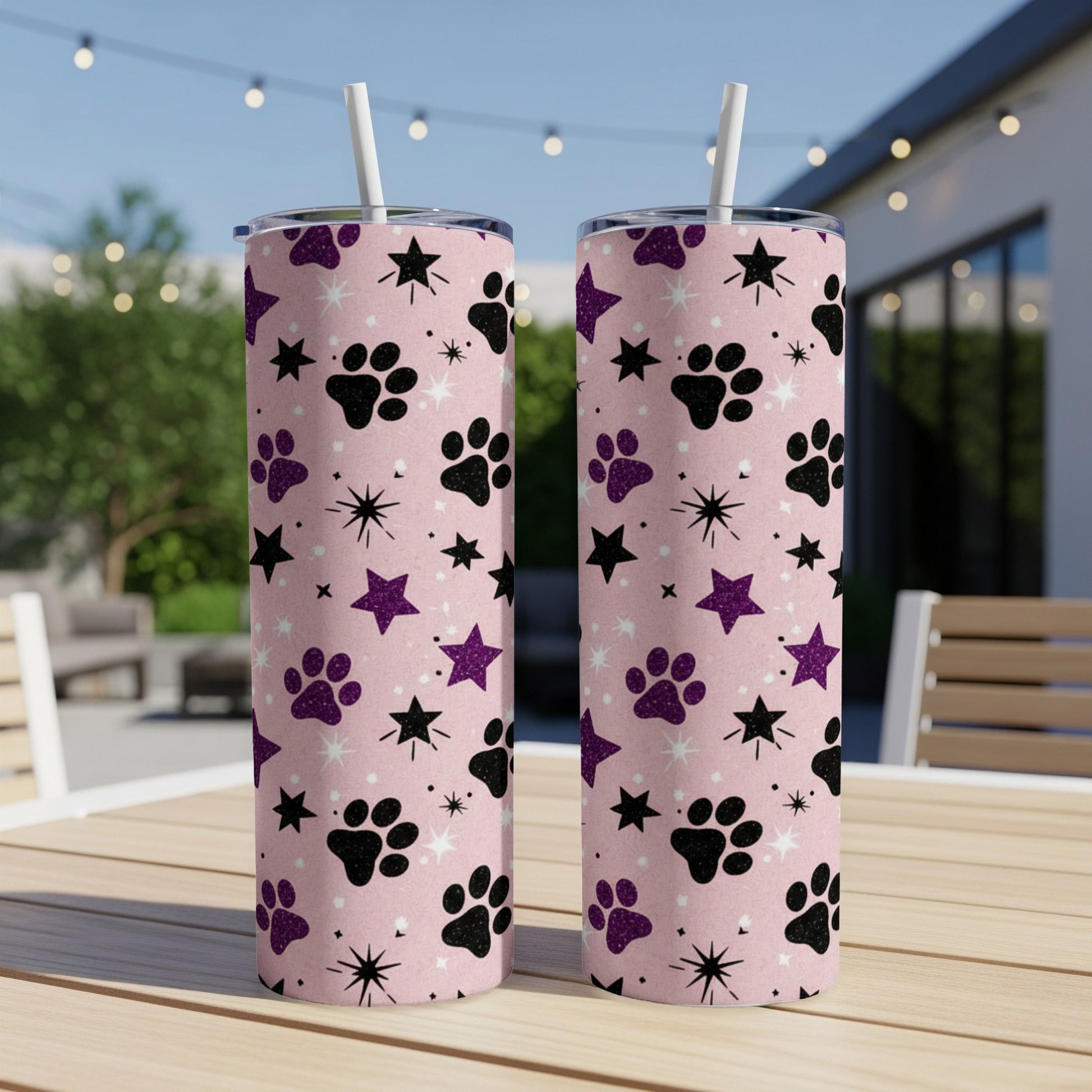 Two pink tumblers with paw print and star pattern.