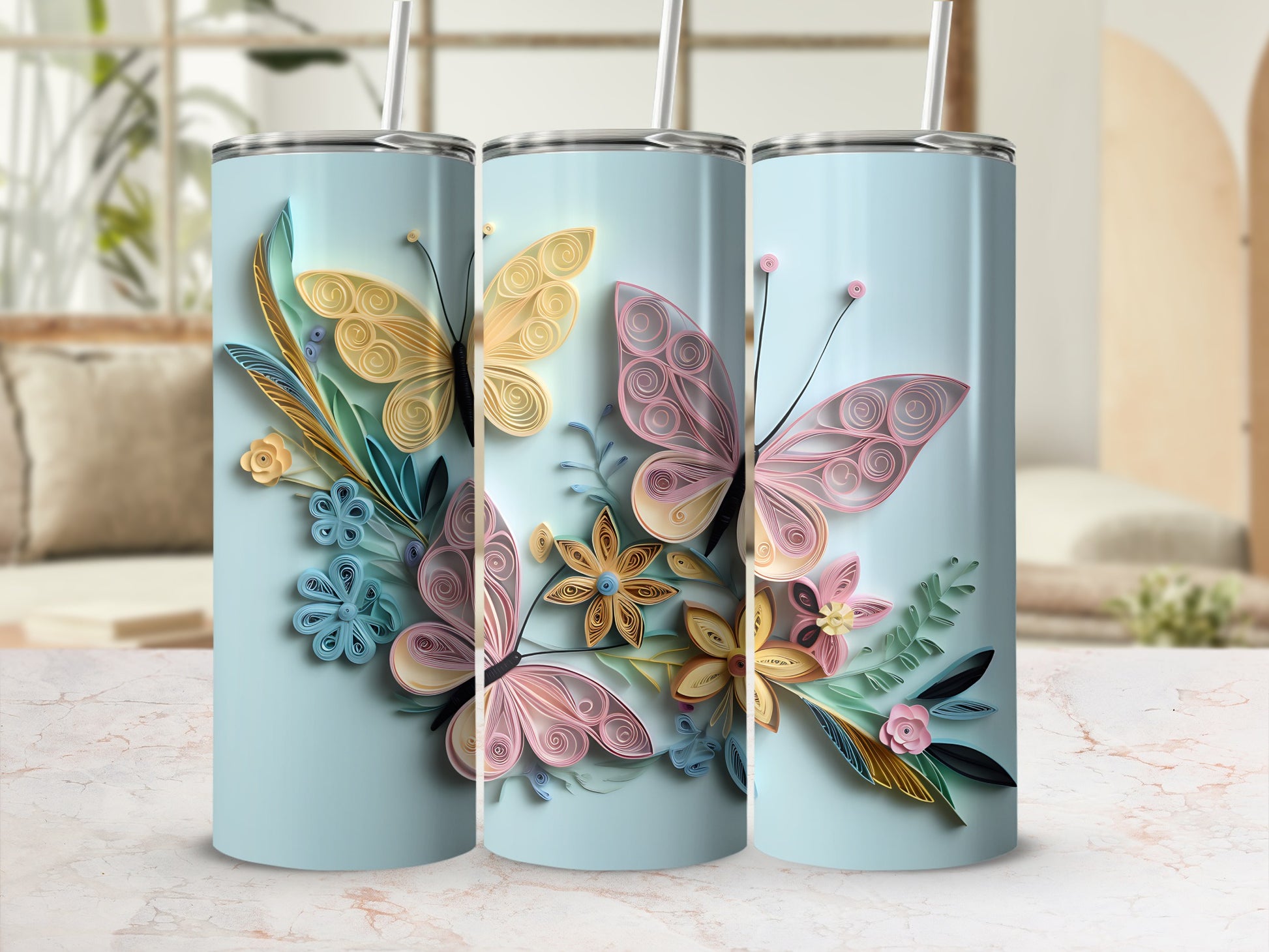 Three tumblers with pastel quilled butterflies and floral designs on a light blue background.