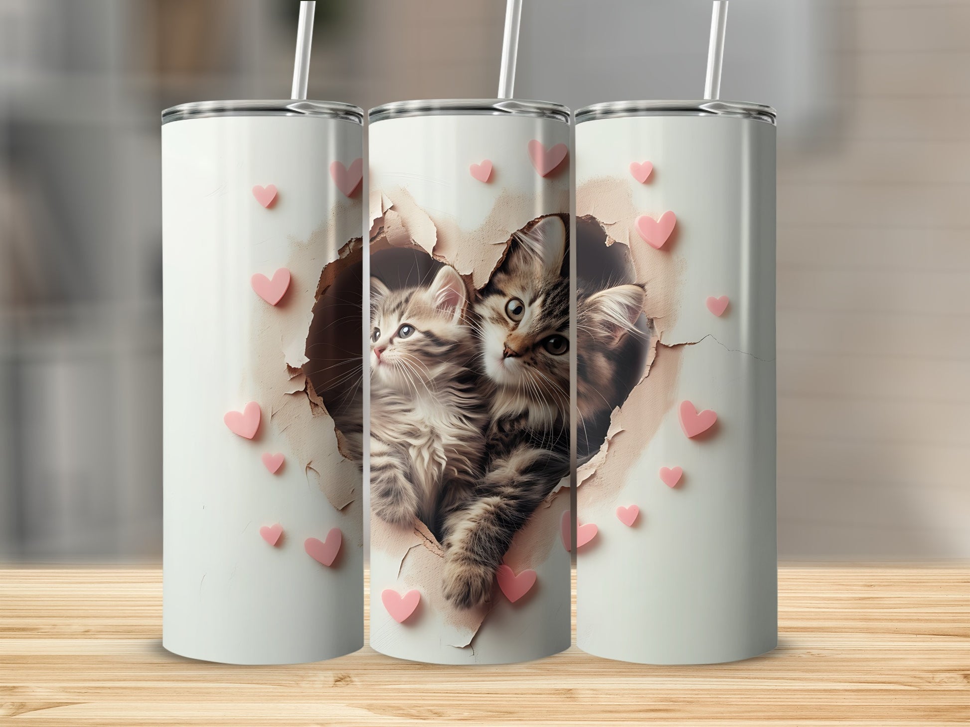 Two kittens peek through a heart-shaped hole in a white tumbler.