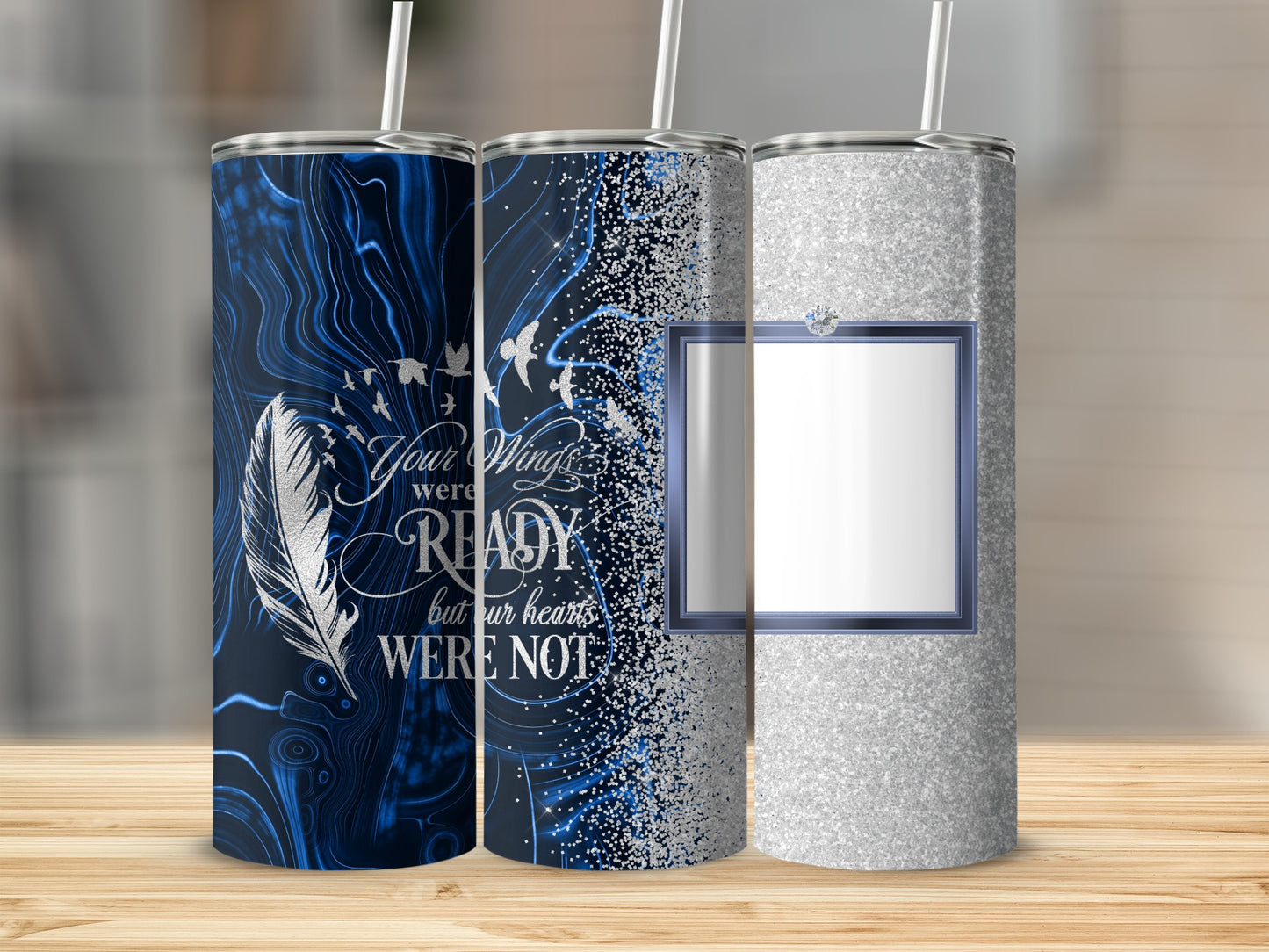 Three tumblers with feather, wings, and glitter designs.