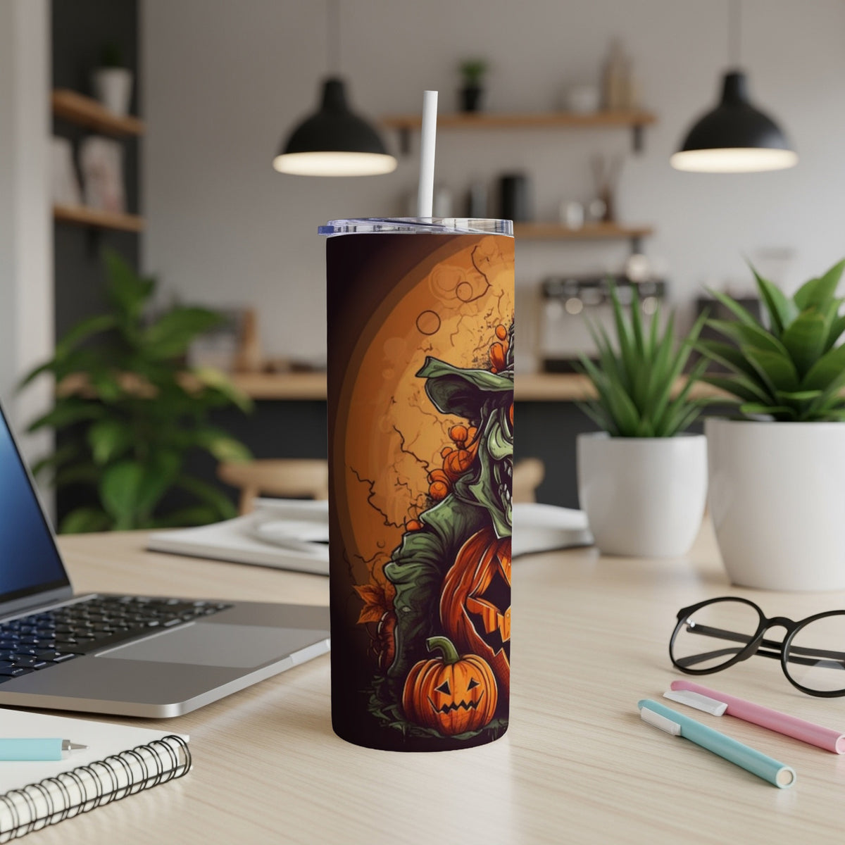 Tall tumbler with Halloween scarecrow and pumpkin illustration, featuring a straw.