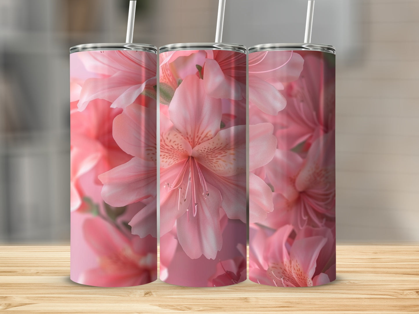 Pink floral pattern on three tumblers with straws.